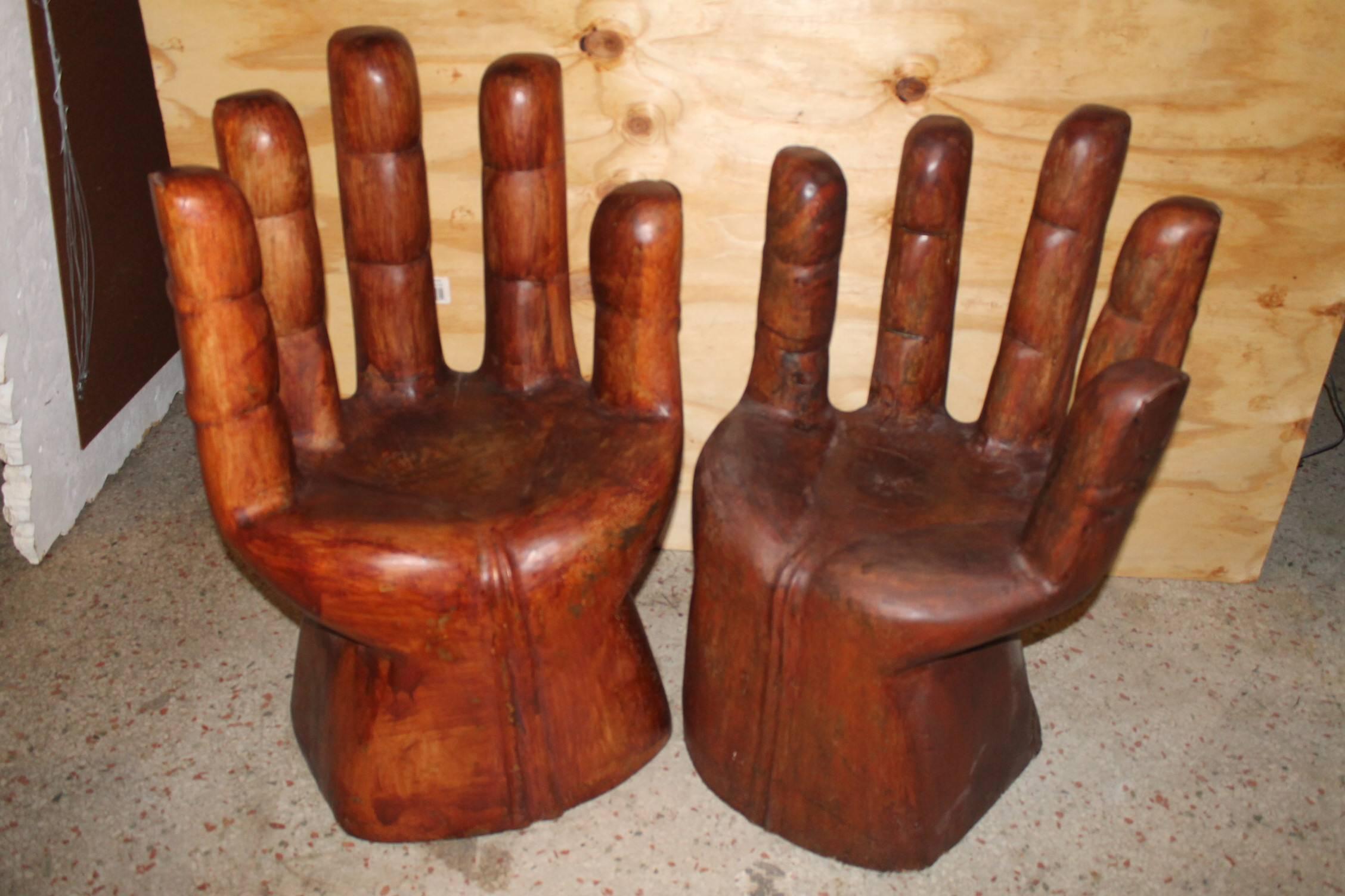 Pair of solid wood carved vintage Hollywood Regency hand chairs in the manner of Pedro Friedeberg. These are solid and heavy! Natural carved wood so there may be natural cracks to the wood. These can be refinished in a stain or professionally