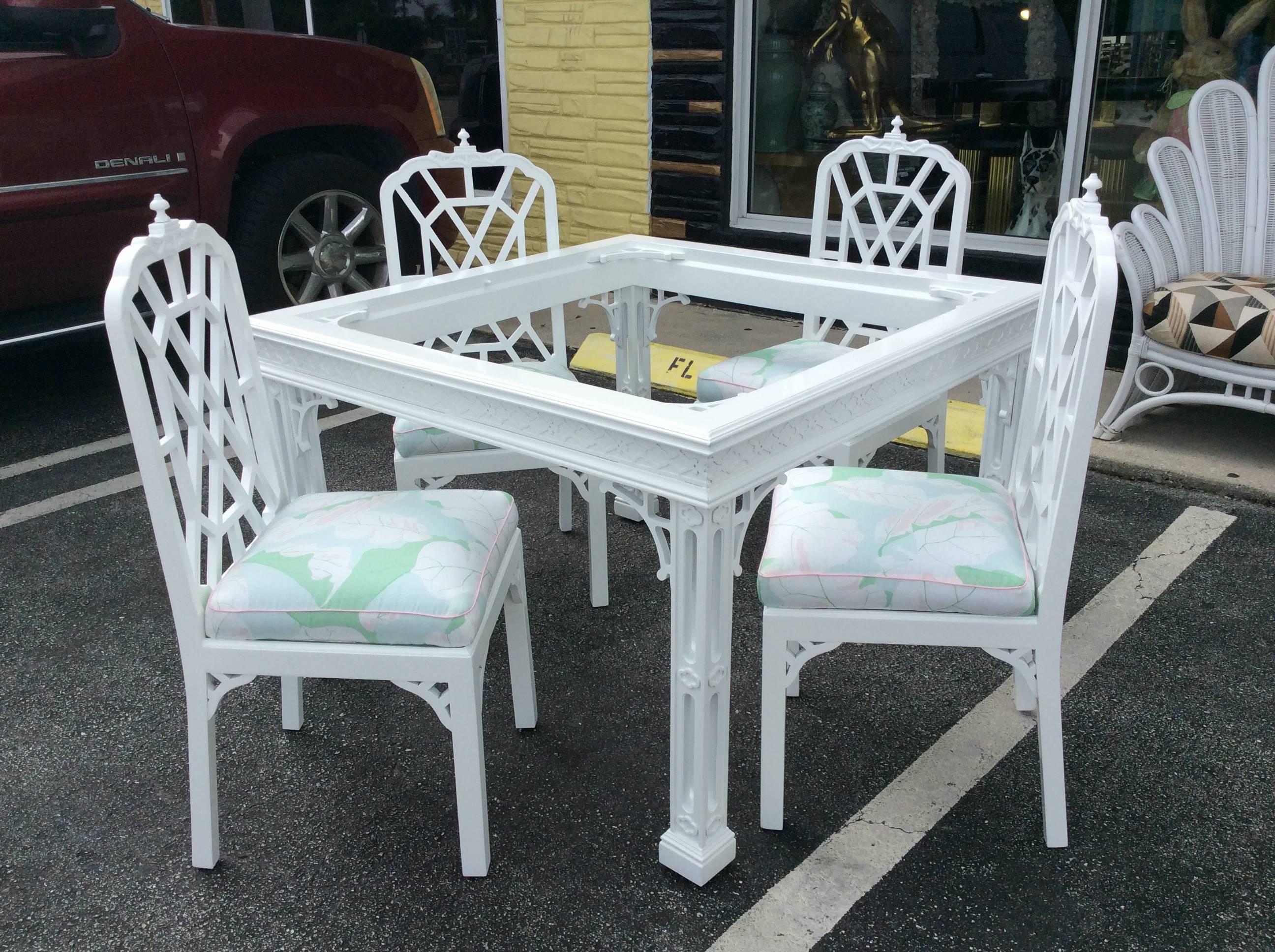 Absolutely amazing vintage Hollywood Palm Beach Regency set that includes newly lacquered fretwork Chinese Chippendale game or dining table, set of four newly lacquered white pagoda side chairs. Glass top for table is included. Chairs have been