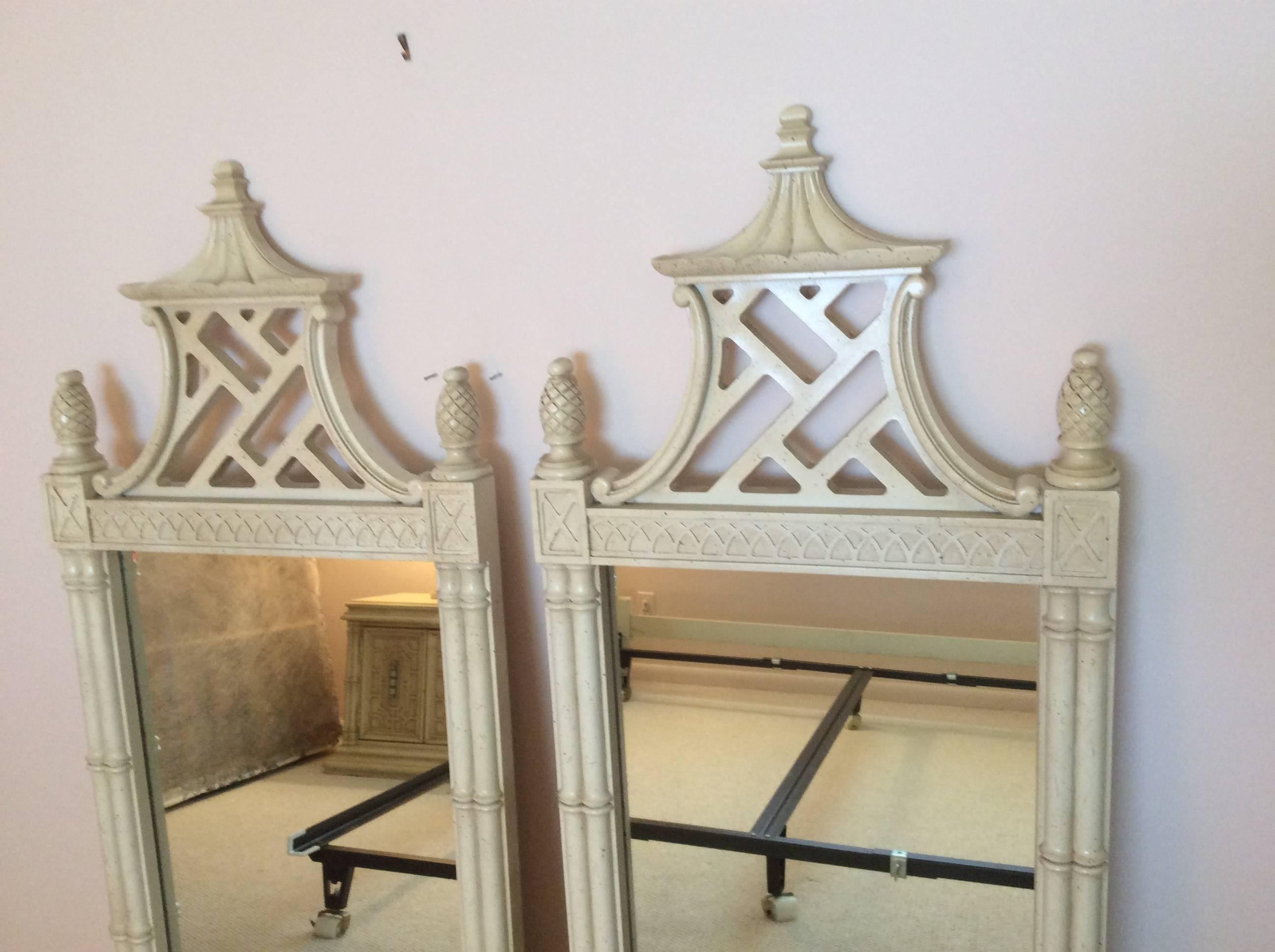 Amazing vintage pair of very rare, hard to find Thomasville pagoda wall mirrors with faux bamboo, pineapple finials and fretwork details. These are NEWLY professionally LACQUERED in a gloss white. 
Faux bamboo, Chinese Chippendale, Palm Beach,