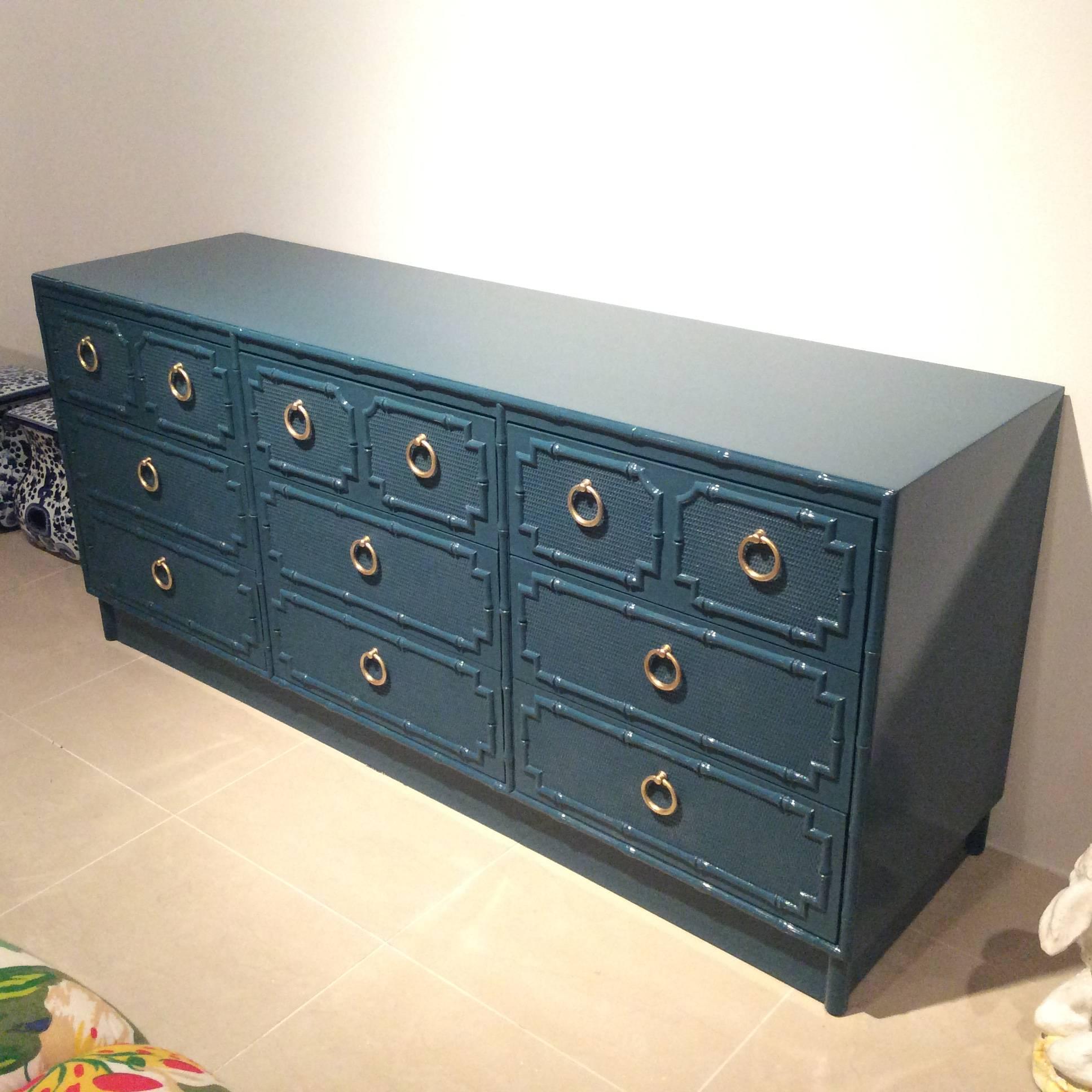 Amazing vintage faux bamboo nine-drawer dresser newly lacquered in a teal peacock blue with lovely polished brass ring hardware.
Matching nightstands available.
Hollywood Regency, Chinese Chippendale, chinoiserie, Palm beach, dresser, credenza,