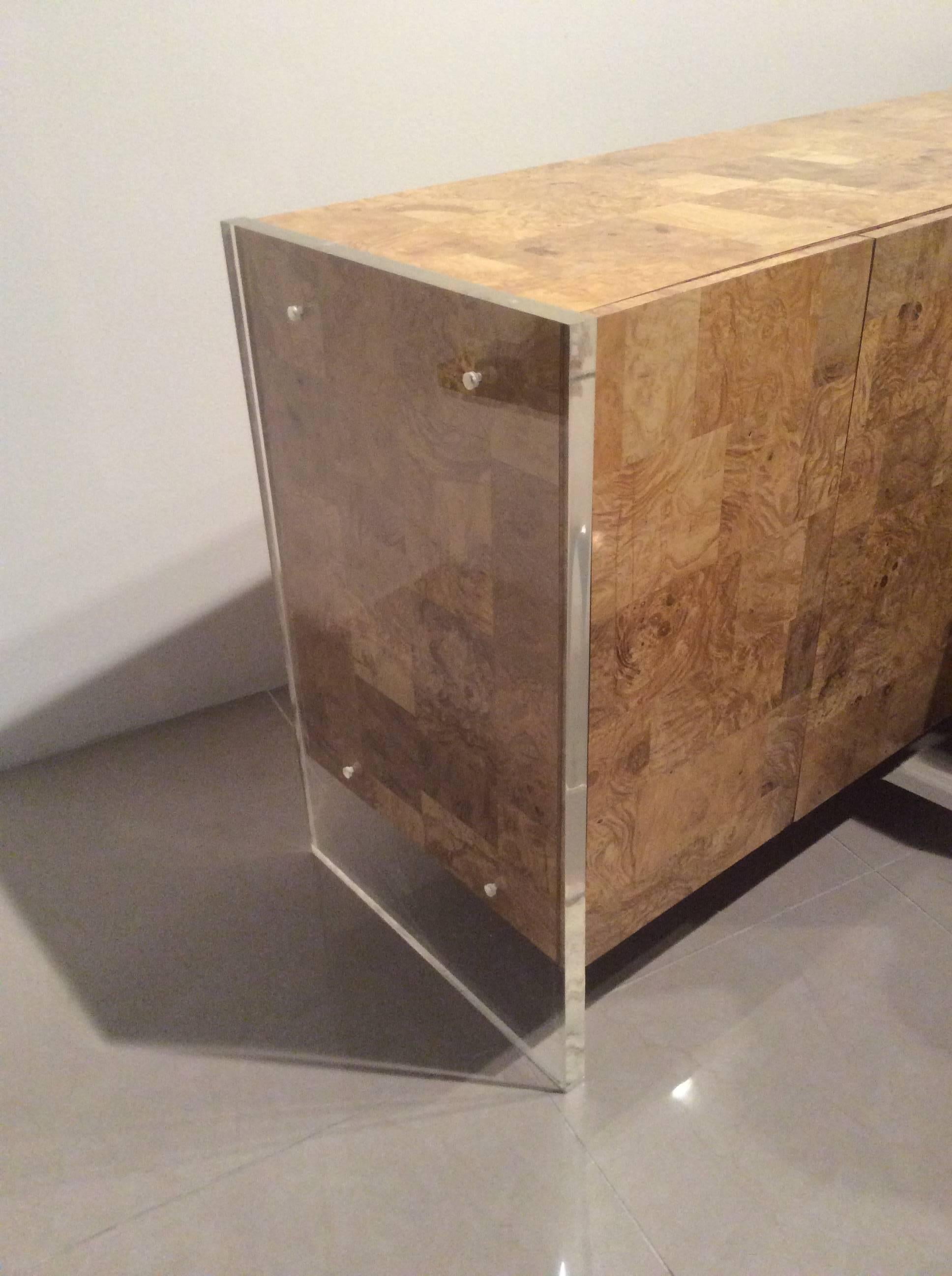 Vintage Hollywood Regency patchwork faux burl wood with Lucite ends credenza, six-door. This piece is finished on all sides including the back so it can literally be placed anywhere in a room since the back is as pretty as the front. The thick