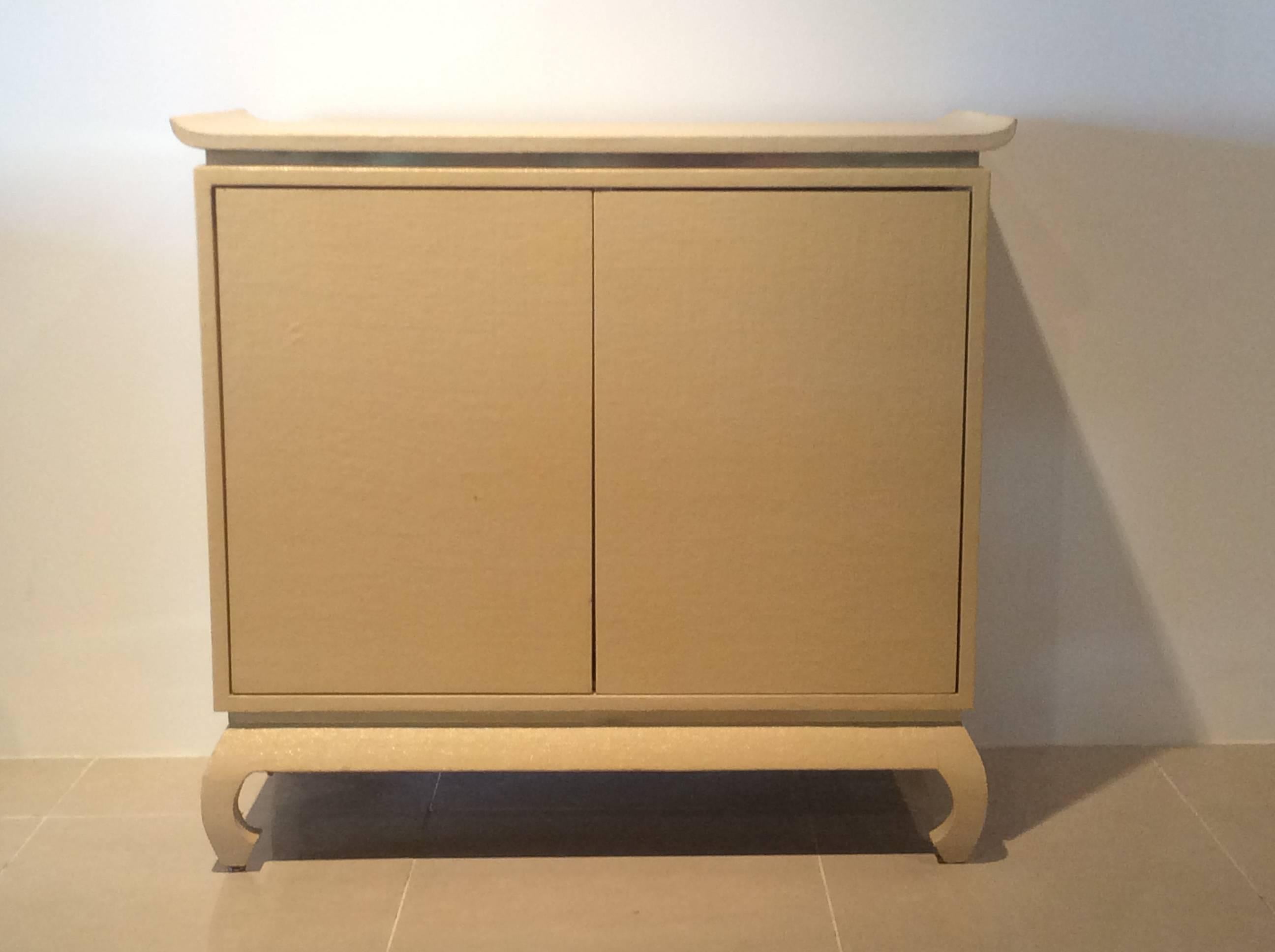 Vintage Hollywood Palm Beach Regency credenza cabinet in a grasscloth linen with brass trim bottom and pagoda top. Karl Springer Style.