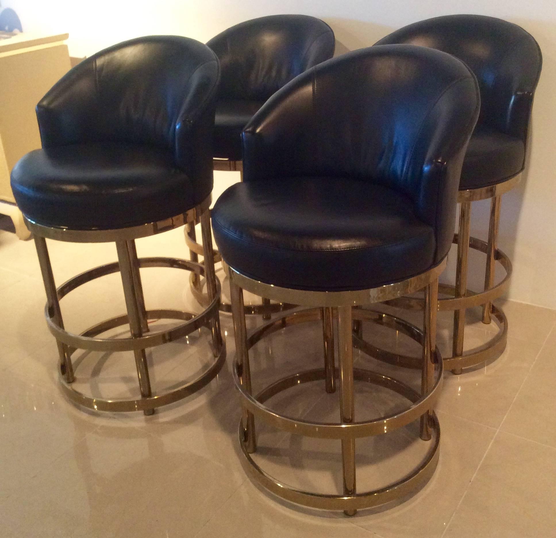 The most amazing set of 4 (four) vintage brass swivel counter or barstools with black leather seats. The leather is in excellent condition with a few minor imperfections. The brass gold base has a few scuffs, tarnishing areas but nothing that