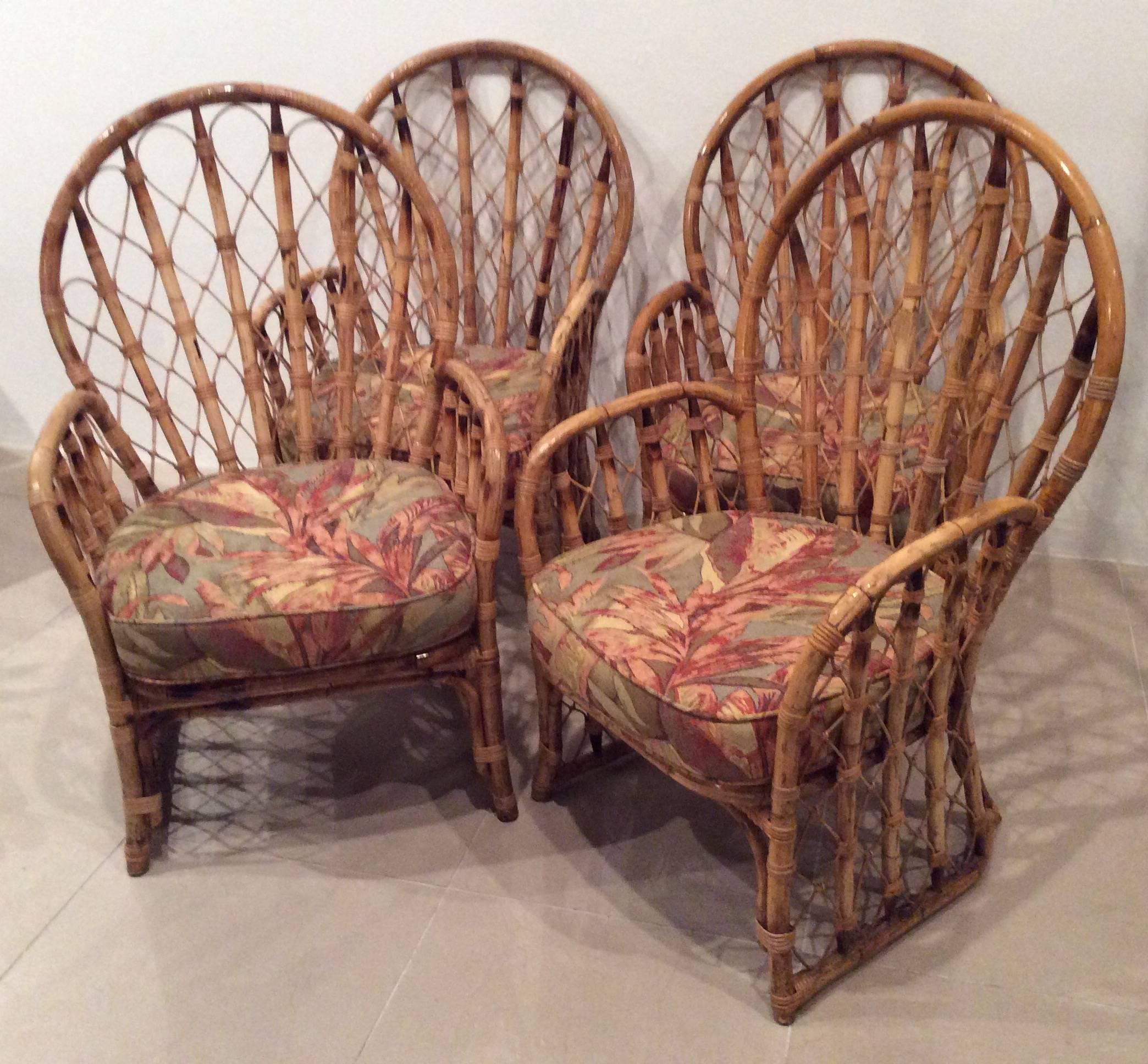 Beautiful set of four faux bamboo high back armchairs. Made in the Philippines. Comes with the cushions. There are a couple pieces of wicker sticks missing. Overall condition is good. Chinese Chippendale Chinoiserie pattern. 
