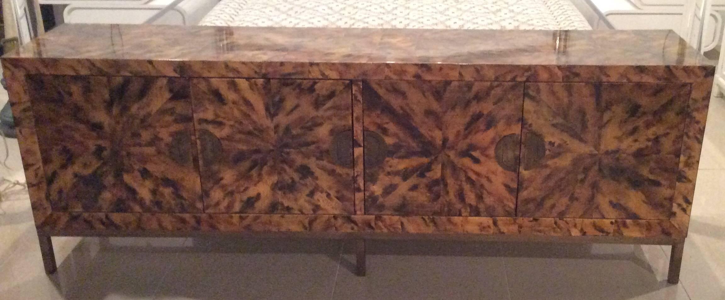 Such an amazing, one of a kind credenza, buffet, dresser. Four doors open to cabinet (inside shown) Unique brass hardware and brass base. Patchwork tortoise shell finish with shiny lacquered top coat.