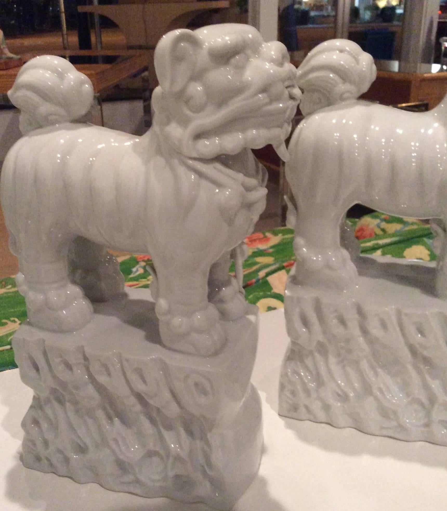 Lovely pair of vintage Italian Foo Dogs in a white chine de blanc. There are no chips or breaks.  Perfect for the oriental, Asian, Hollywood Regency decor. 