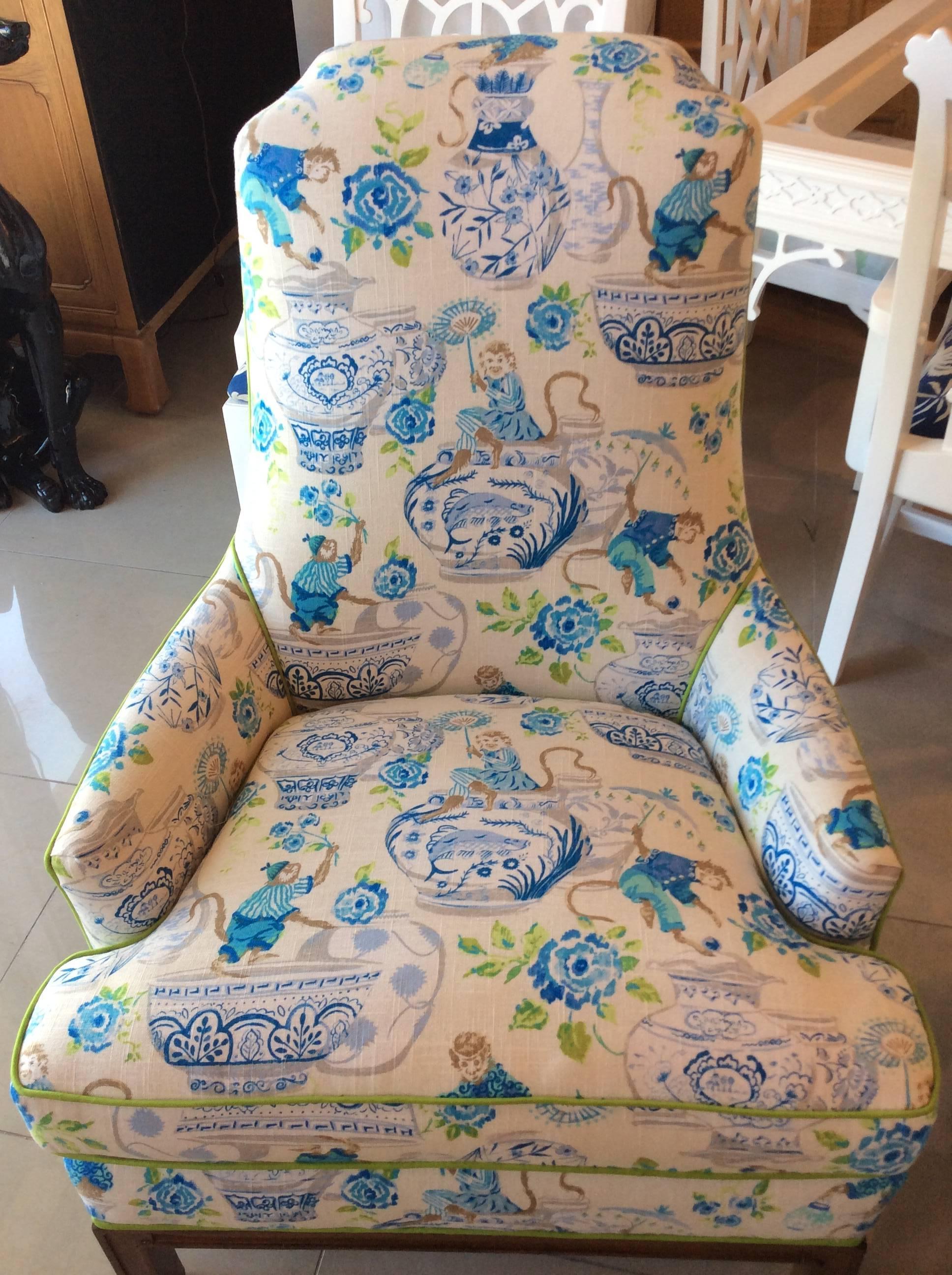 Amazing pair of vintage Mid-Century Modern armchairs, club, lounge, barrel back with wood base. Newly upholstered and cushioned with a great linen chinoiserie fabric with monkeys, blue and white ginger chairs, all piped in a coordinating green trim.