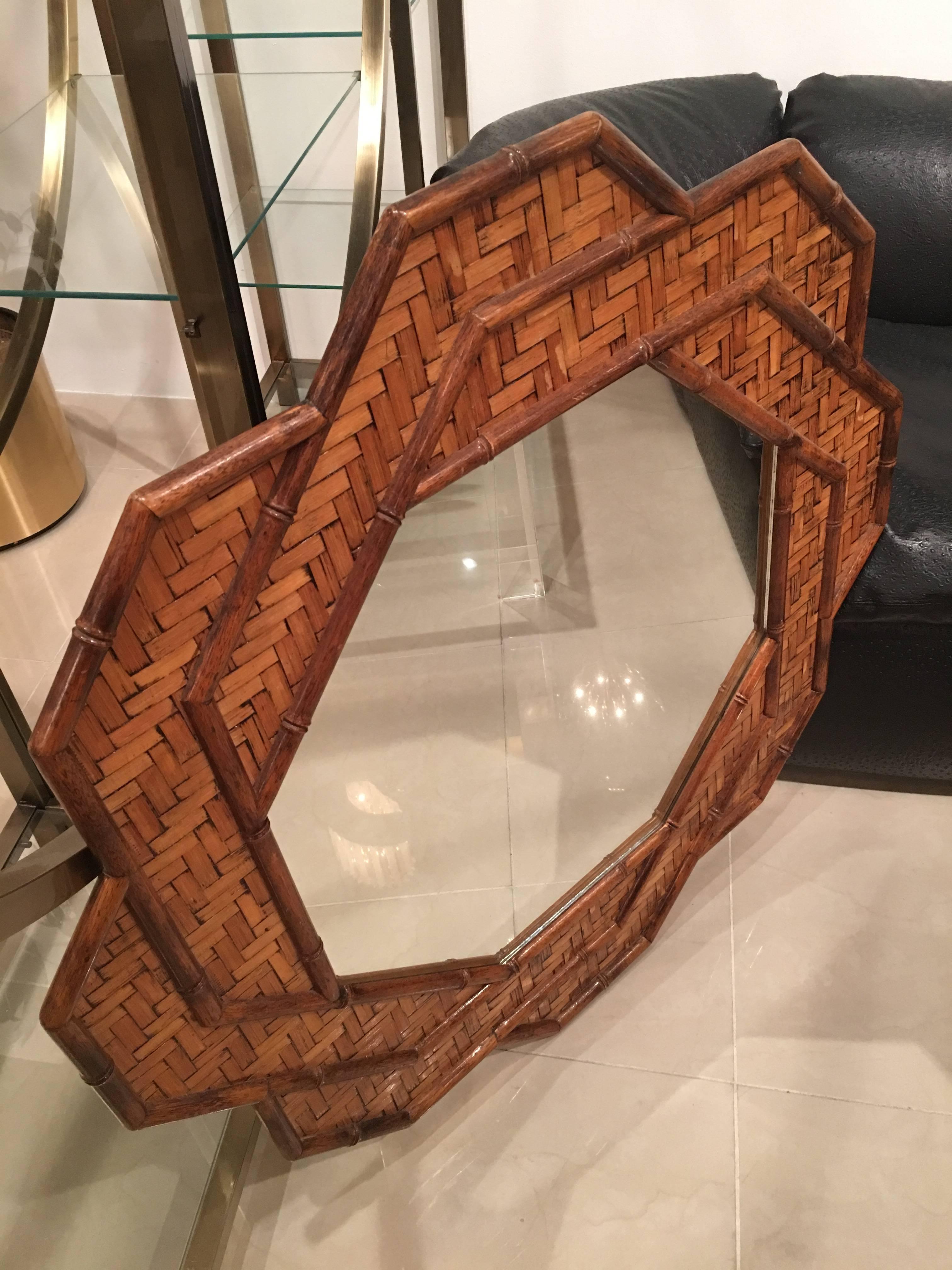 Beautiful vintage Hollywood Regency octagonal wall mirror. Woven rattan, bamboo, pencil reed, wicker tropical Palm Beach mirror. Comes ready to hang.