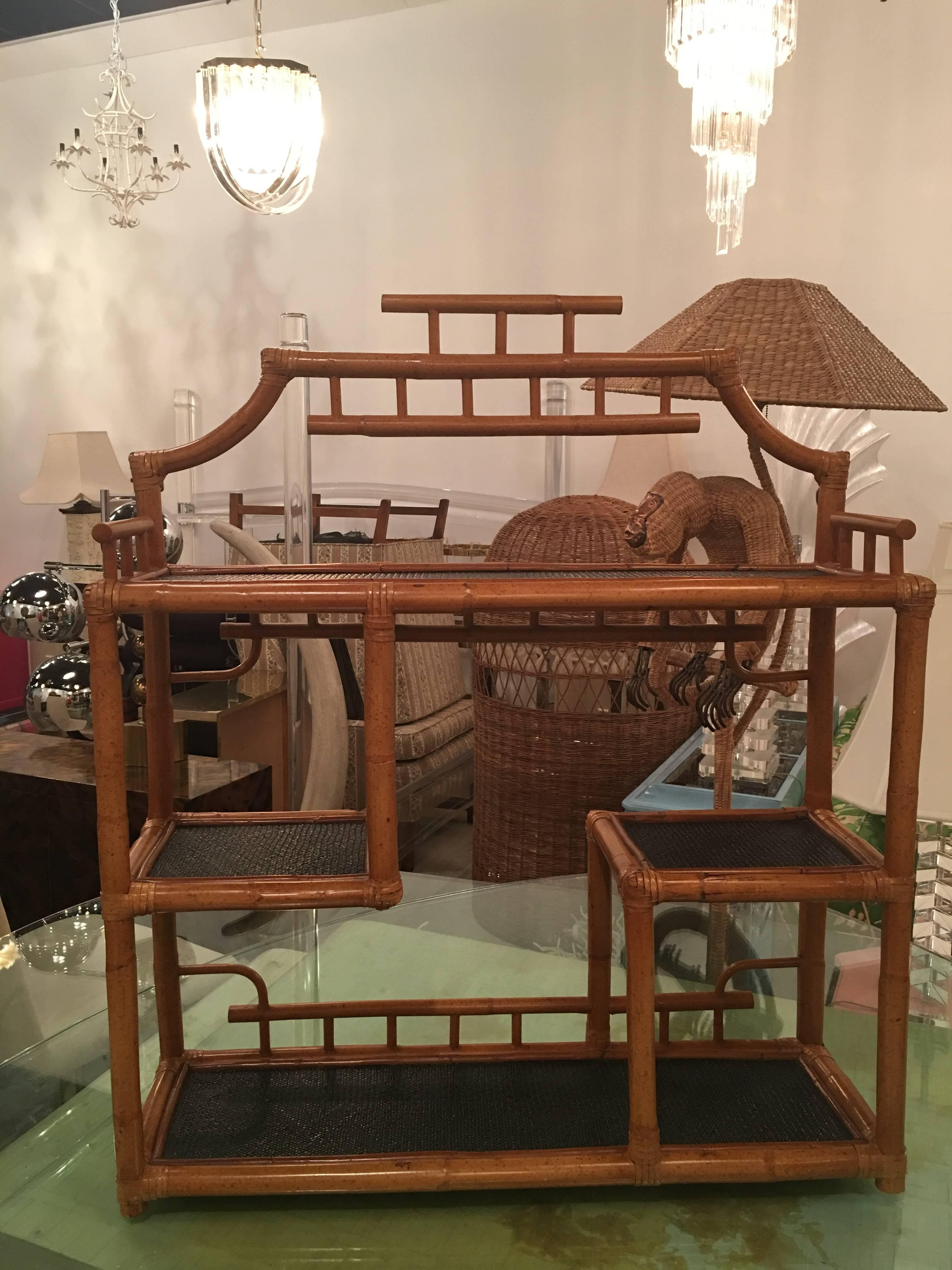 Vintage pagoda rattan, bamboo shelf. This can be used on the floor as an etagere, on top of a piece of existing furniture or comes with mounting hardware ready to hang on the wall. Great tropical, palm beach chinoiserie piece.