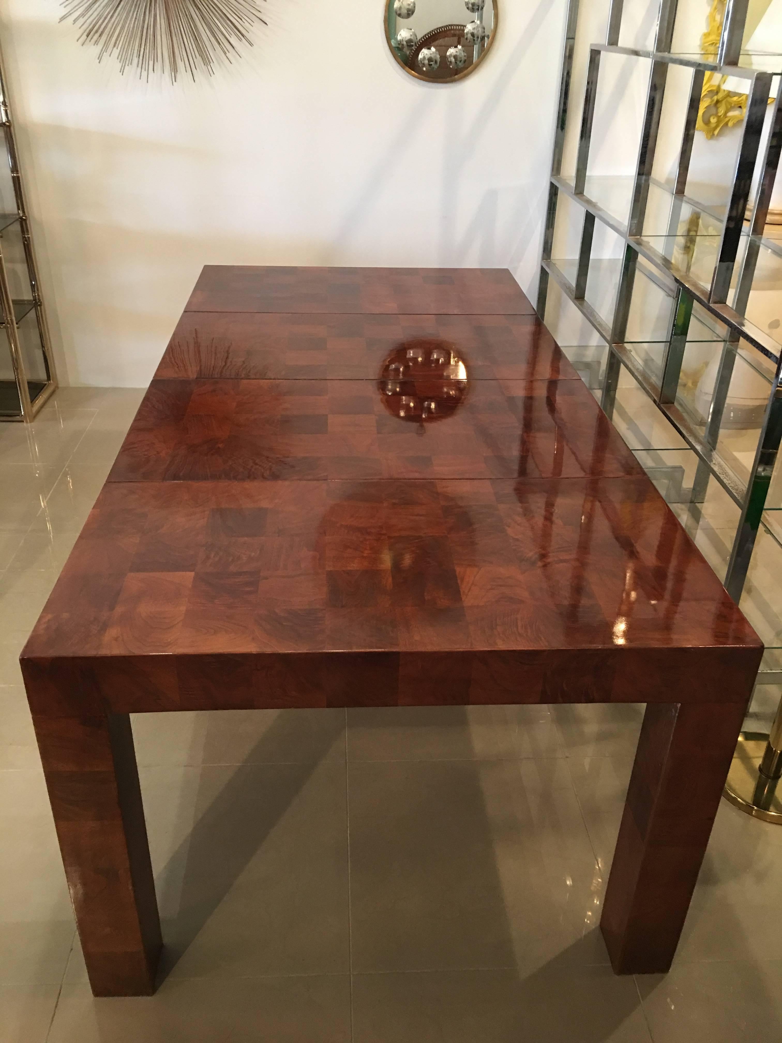 Amazing vintage Milo Baughman patchwork burl wood Parsons dining table. This is shown with two extension leaves that are included. This table has been professionally restored. With two leaves measures 80 long, closed with no leaves measures 40. Each
