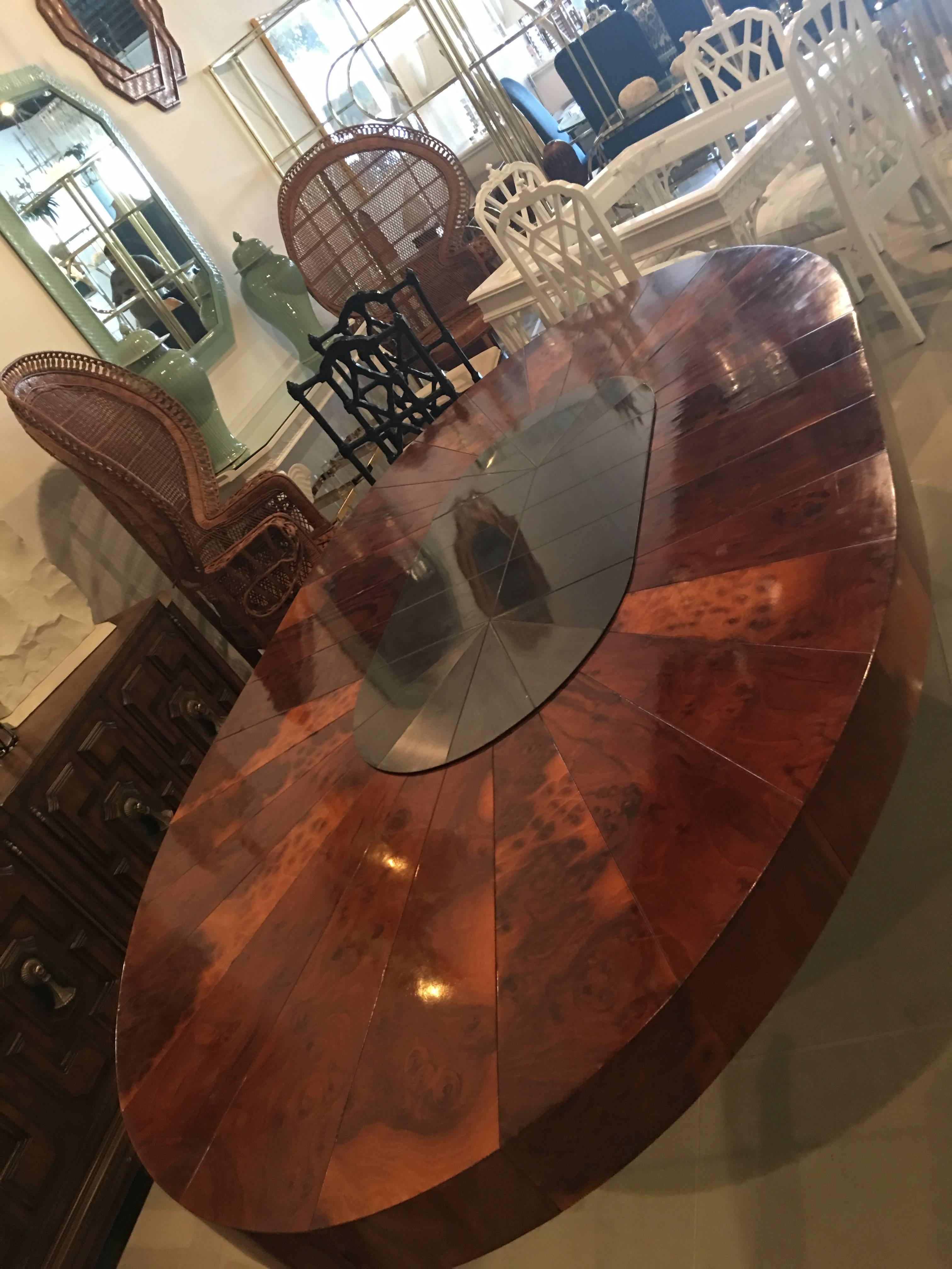 Amazing vintage Paul Evans Cityscape burl wood and brushed metal dining table. Metal base and top piece with burl wood top. Starburst design. Includes 1 table leaf extension which is 20 in wide. With the one leaf in the table it measures 93 long