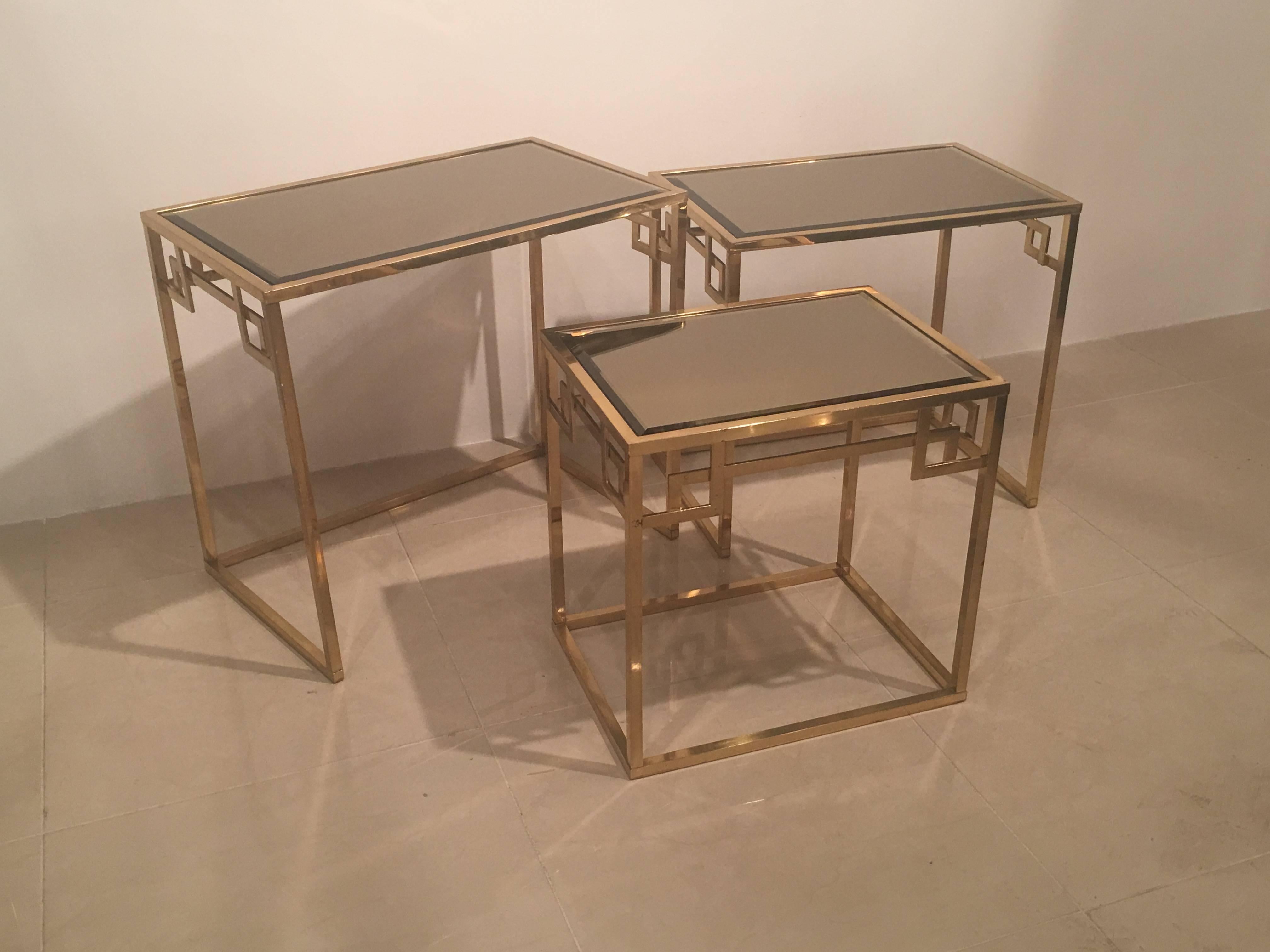 Lovely vintage set of three vintage brass gold Greek key nesting tables in three different sizes. Can be displayed in a few different ways. Made in Italy label underneath. Some patina on brass and glass.
Measures: Small table 17.75 L x 13 D x 17.50