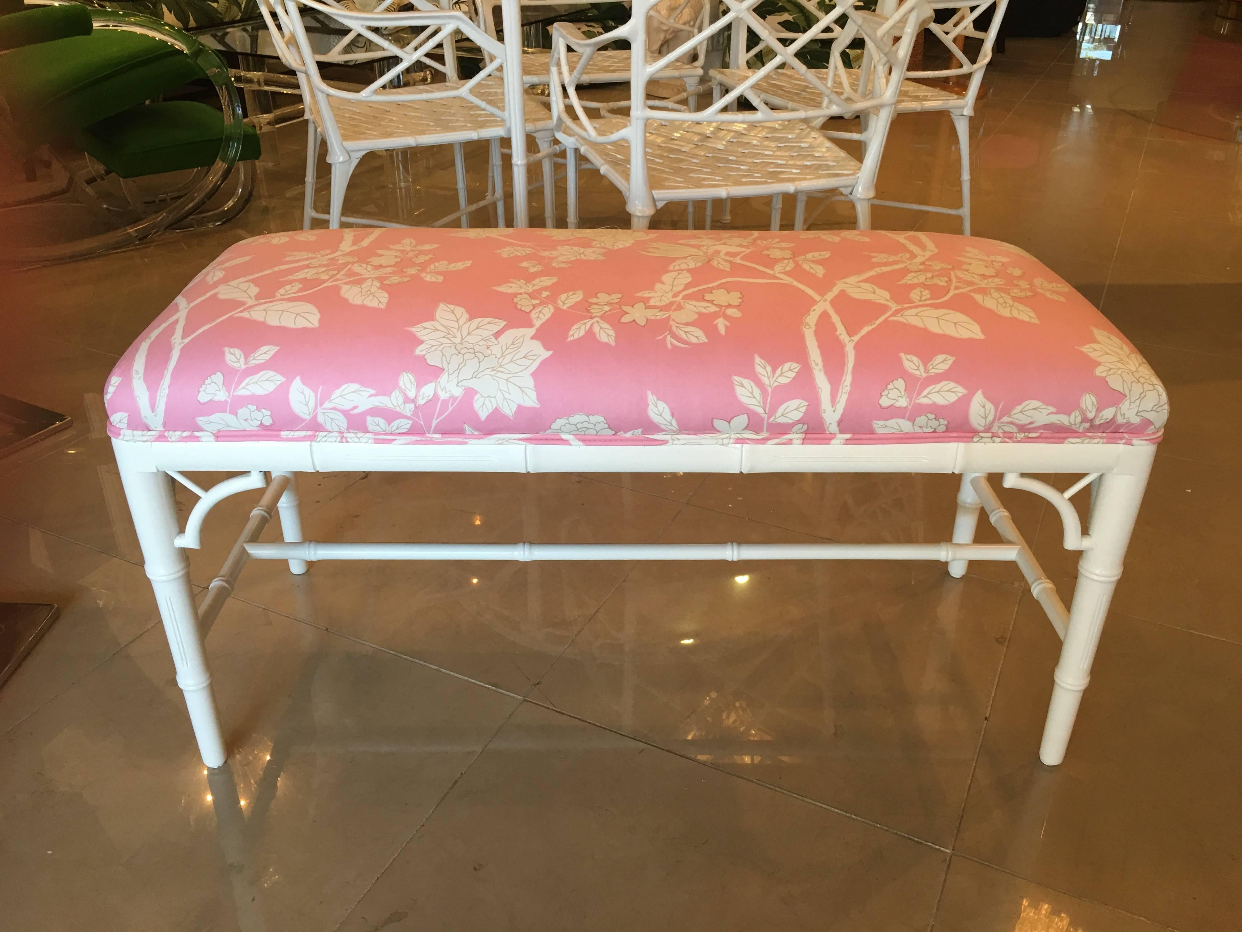 Newly lacquered in a white gloss finish with a newly upholstered pink and white chinoiserie designer fabric faux bamboo, Chinese Chippendale bench. I have a pair of these available. I have more of these available which can be done in a custom