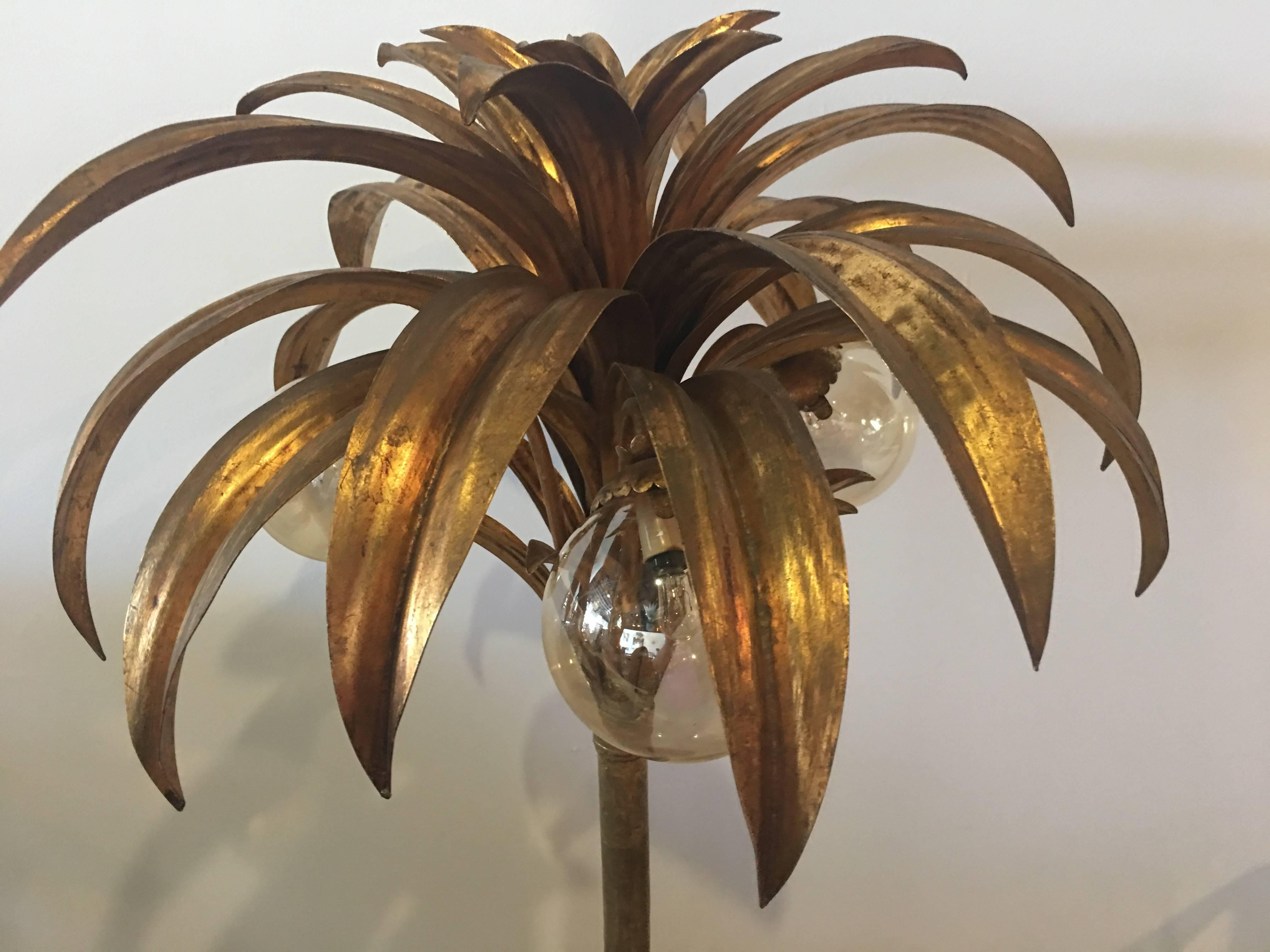 Beautiful vintage gold gilt palm tree floor lamp with three lights that have round glass globes that represent coconuts. Original vintage finish and wiring. In tested working order. Great tropical Palm Beach feel.