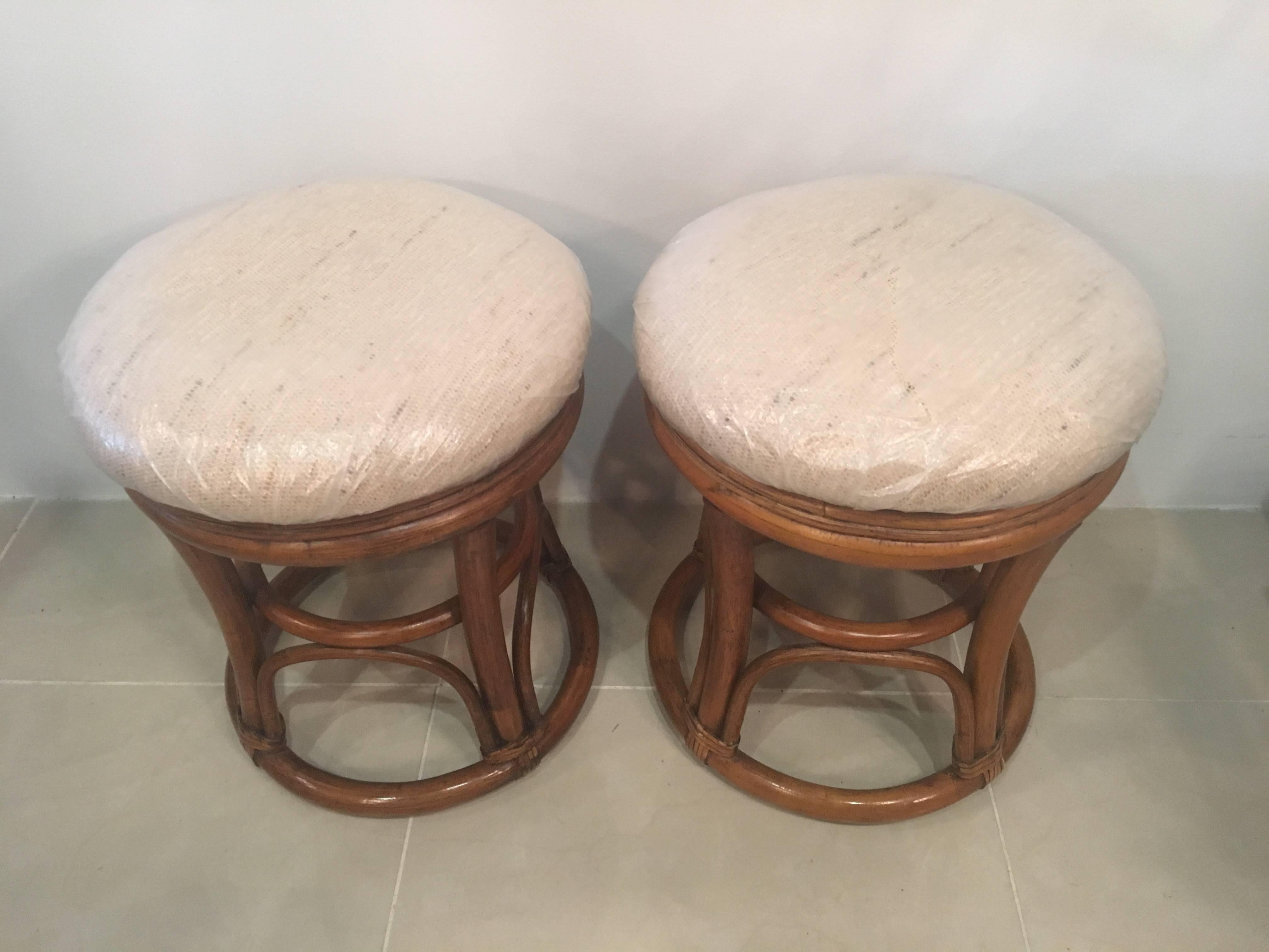 Great pair of vintage rattan stools, benches. These would be perfect under a console table! Newly upholstered (plastic is used to protect the upholstery).