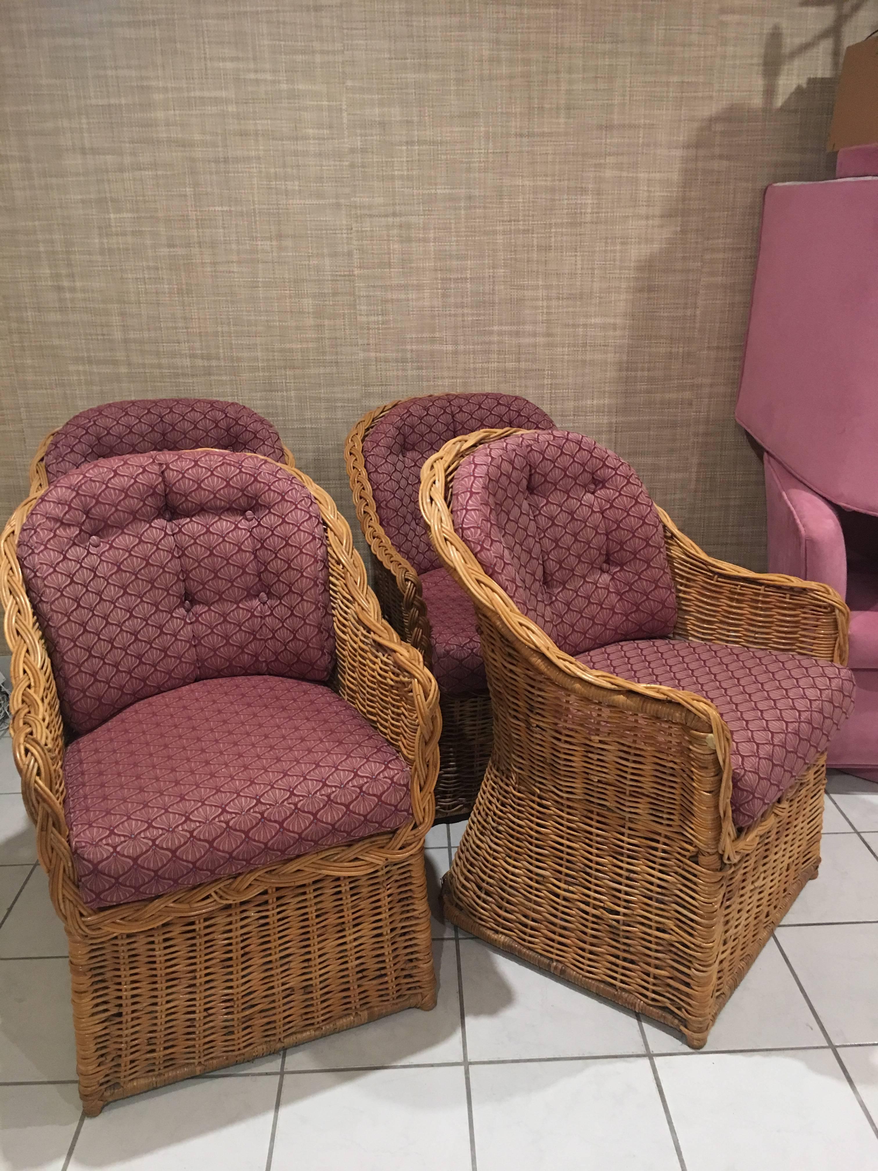 Set of four vintage braided rattan, wicker dining arm chairs. The cushions are removable to expose all the rattan. The cushions are original but have no flaws. Depth below is cushion depth.