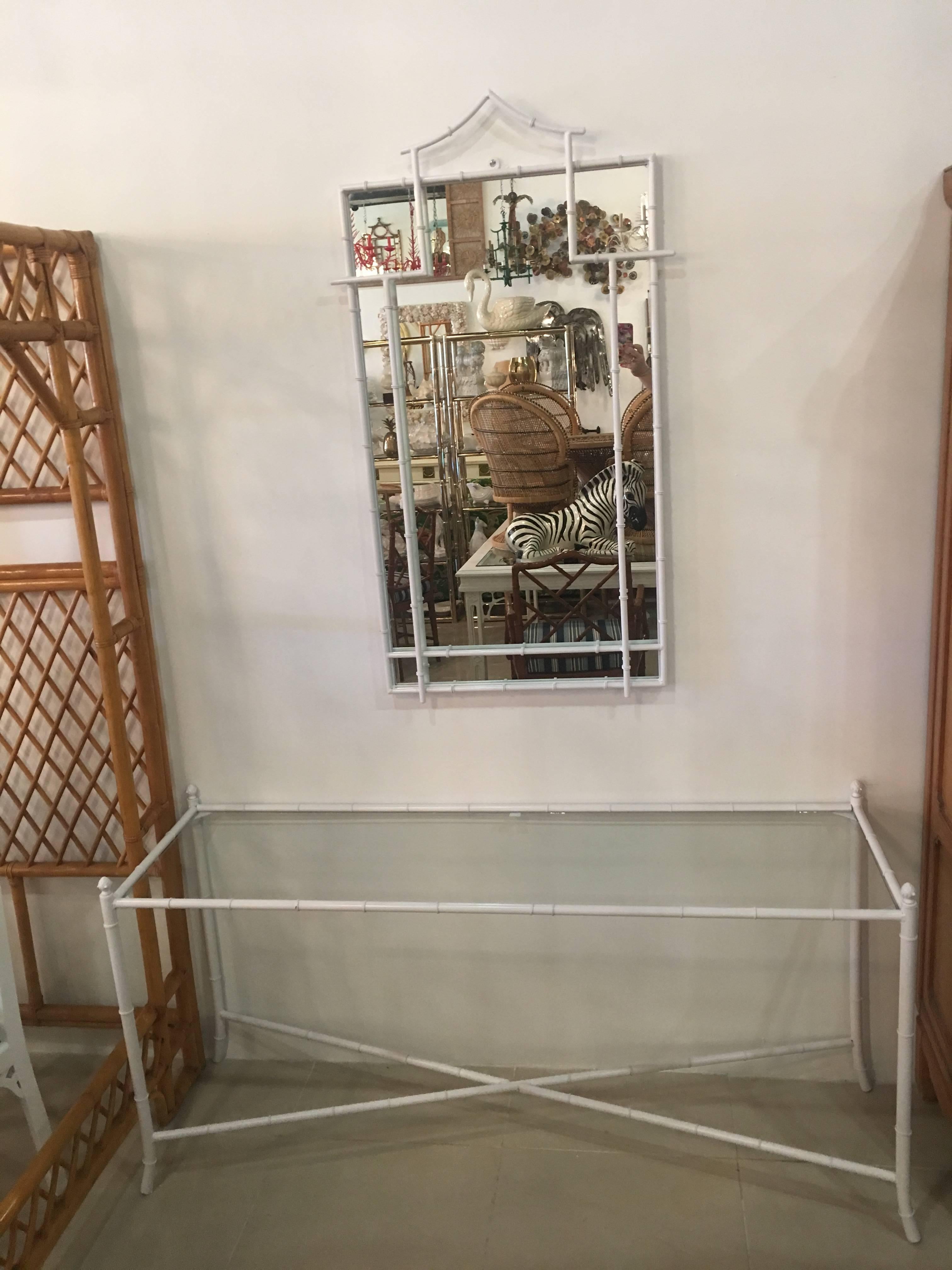 Amazing vintage faux bamboo metal console table with glass top and matching faux bamboo metal pagoda top mirror. Newly finished gloss white. Perfect for inside or a patio area. 
Mirror measures 47.25 tall x 26.5 wide x 1.25 deep.