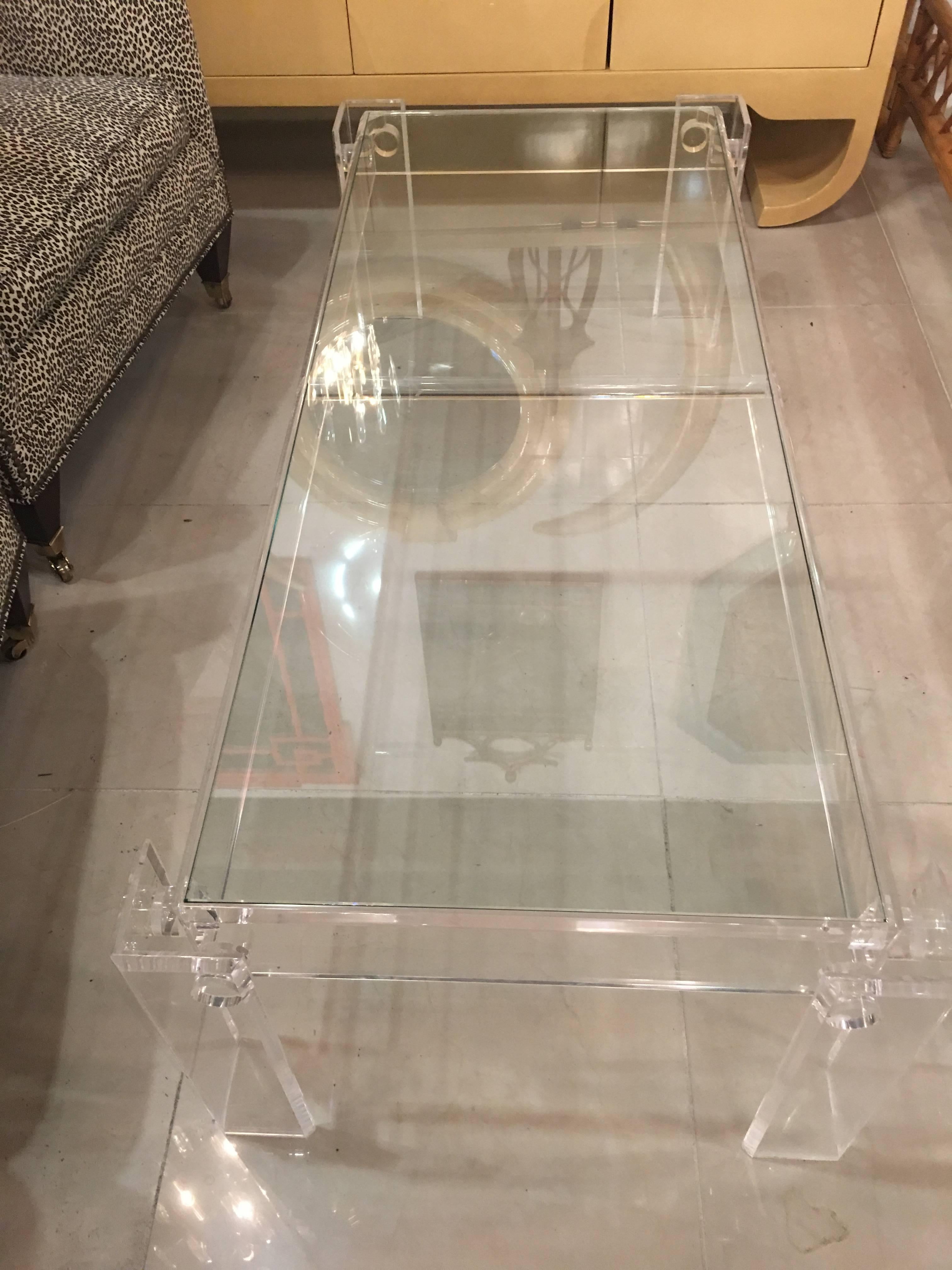 Vintage Lucite rectangular coffee cocktail table with clear Lucite pegs and seamless legs. Glass top included.