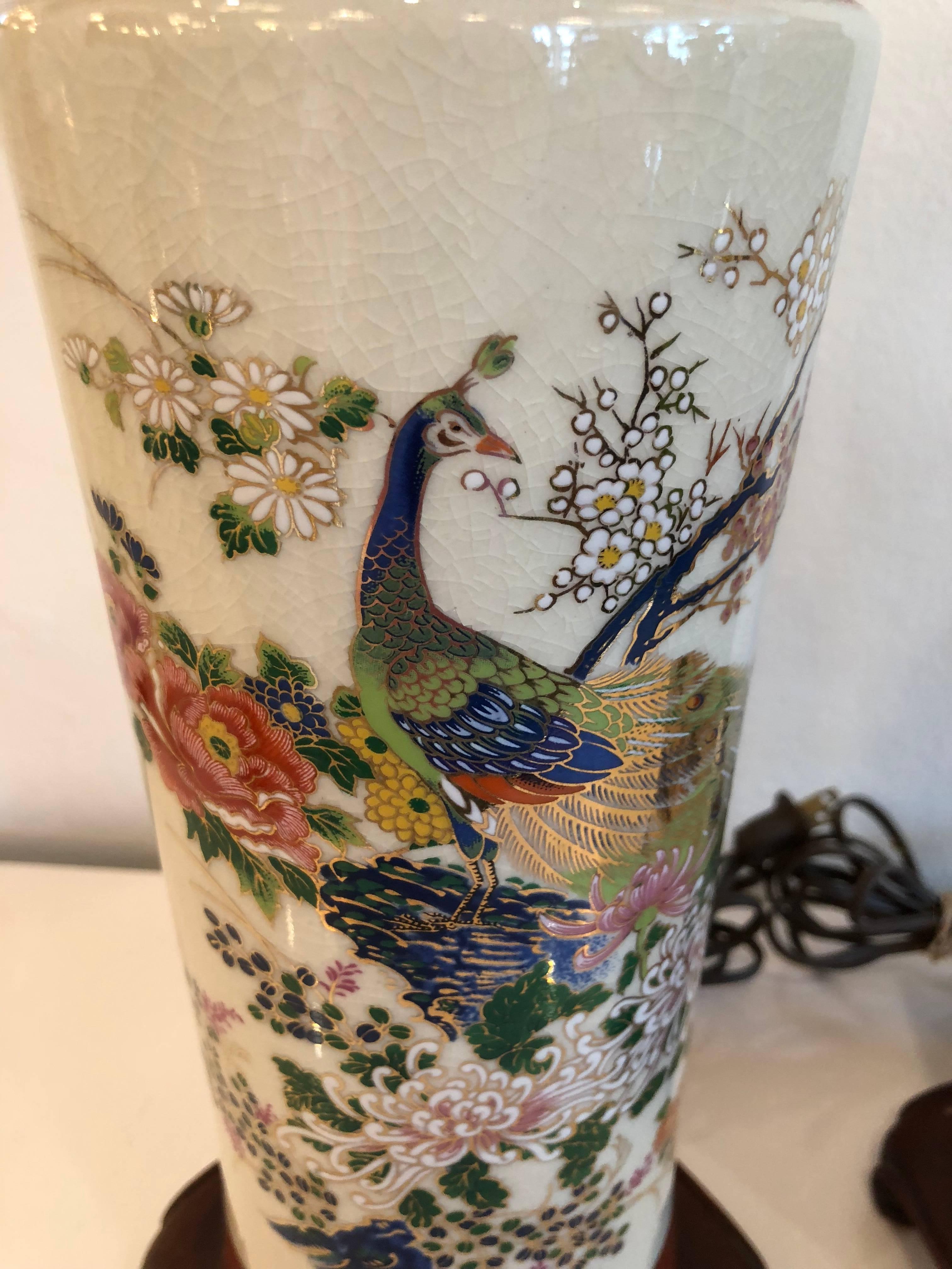 Lovely pair of vintage chinoiserie Table Lamps with lovely colors, peacocks, flowers. Wood ming Base. These will be newly wired prior to shipping.