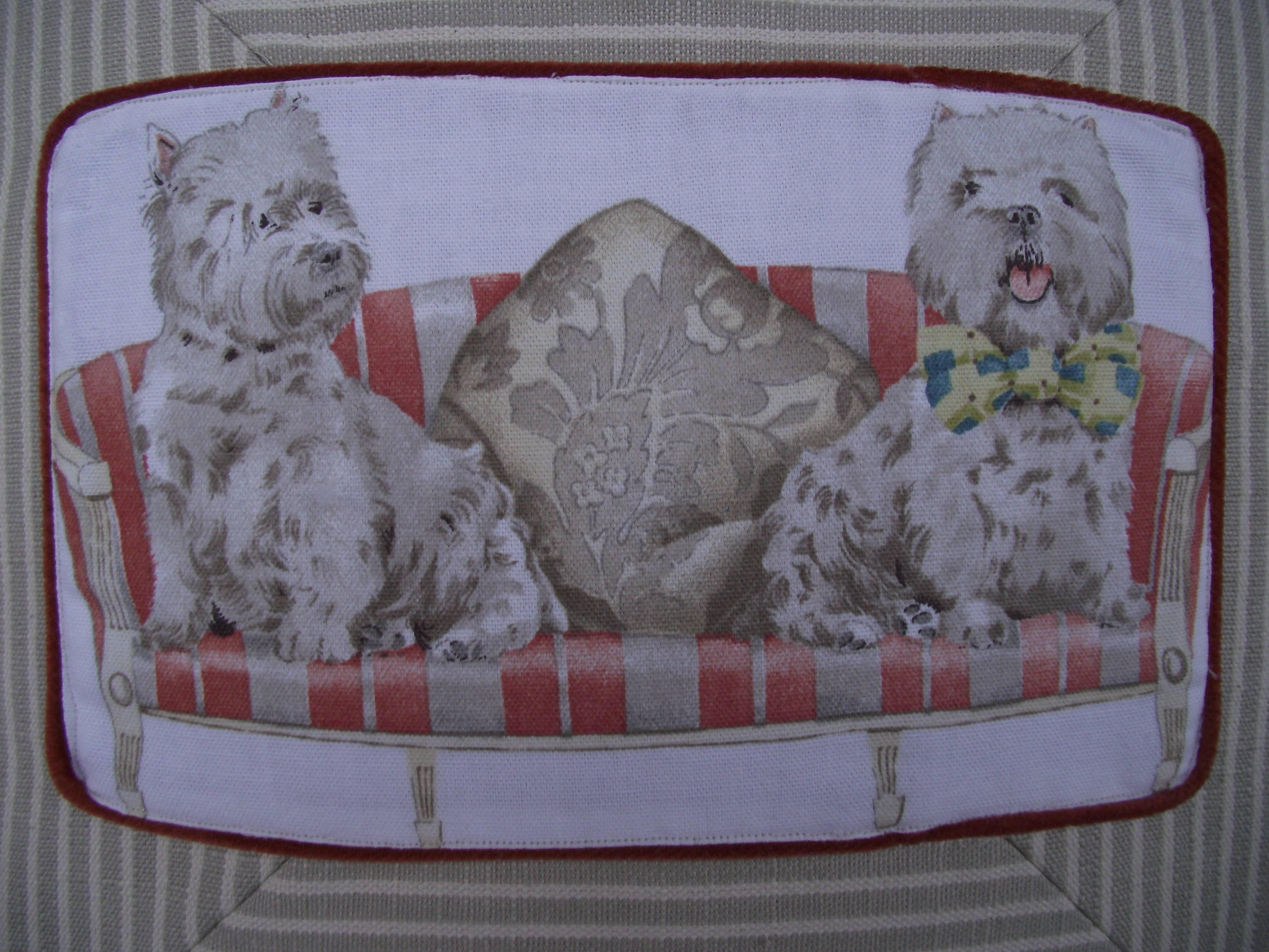 This charming pillow is made using a vintage novelty fabric by Robert Allen Fabrics . Each dog cameo is sewn onto an upholstery grade linen beige and white mitered stripe pillow. 

The pillow has a velcro closure at the bottom and covers a medium