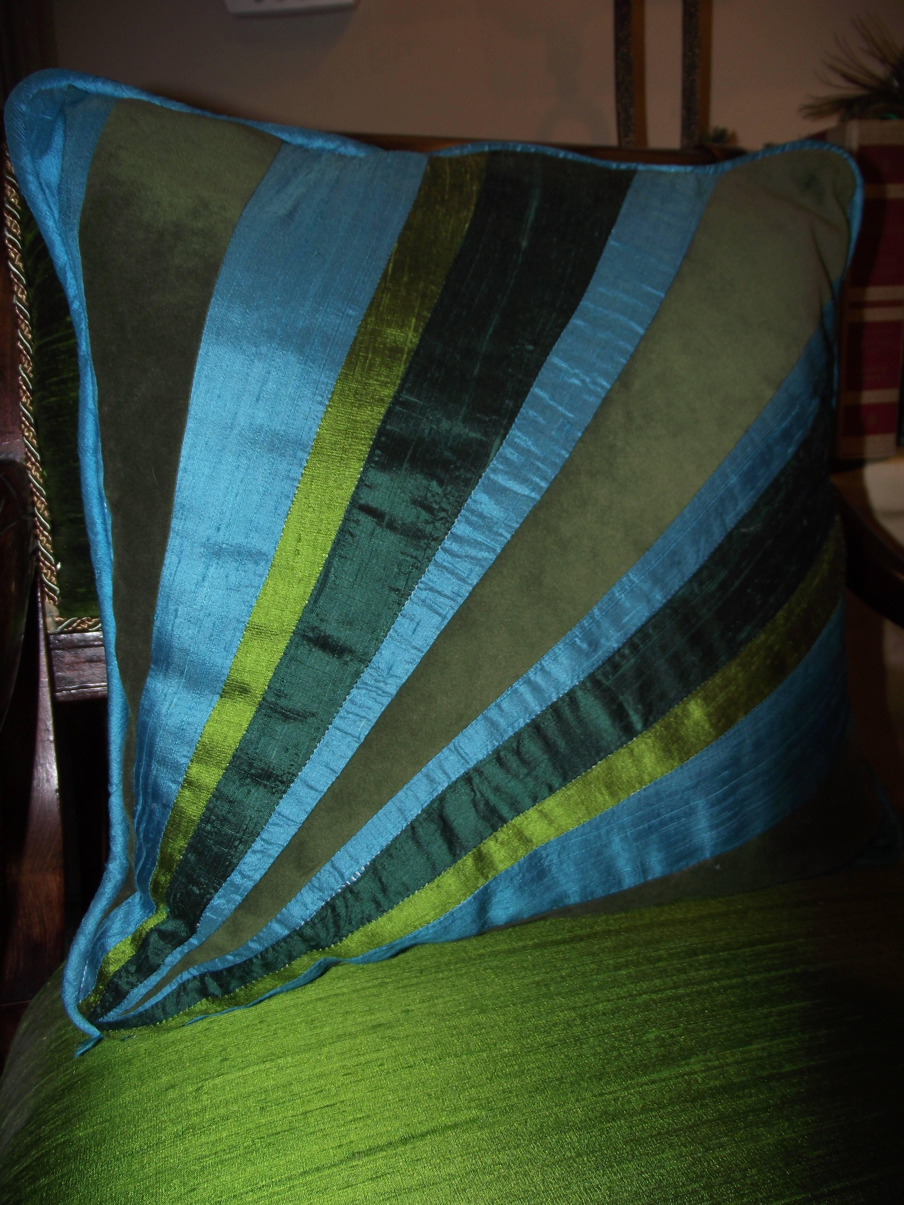 This luxurious throw pillow is a one of a kind design from GANTT Design Studio. The colors are taken directly from a peacock feather. It is a delightful combination of texture featuring velvet and shantung silks. The pillow form is made of a medium