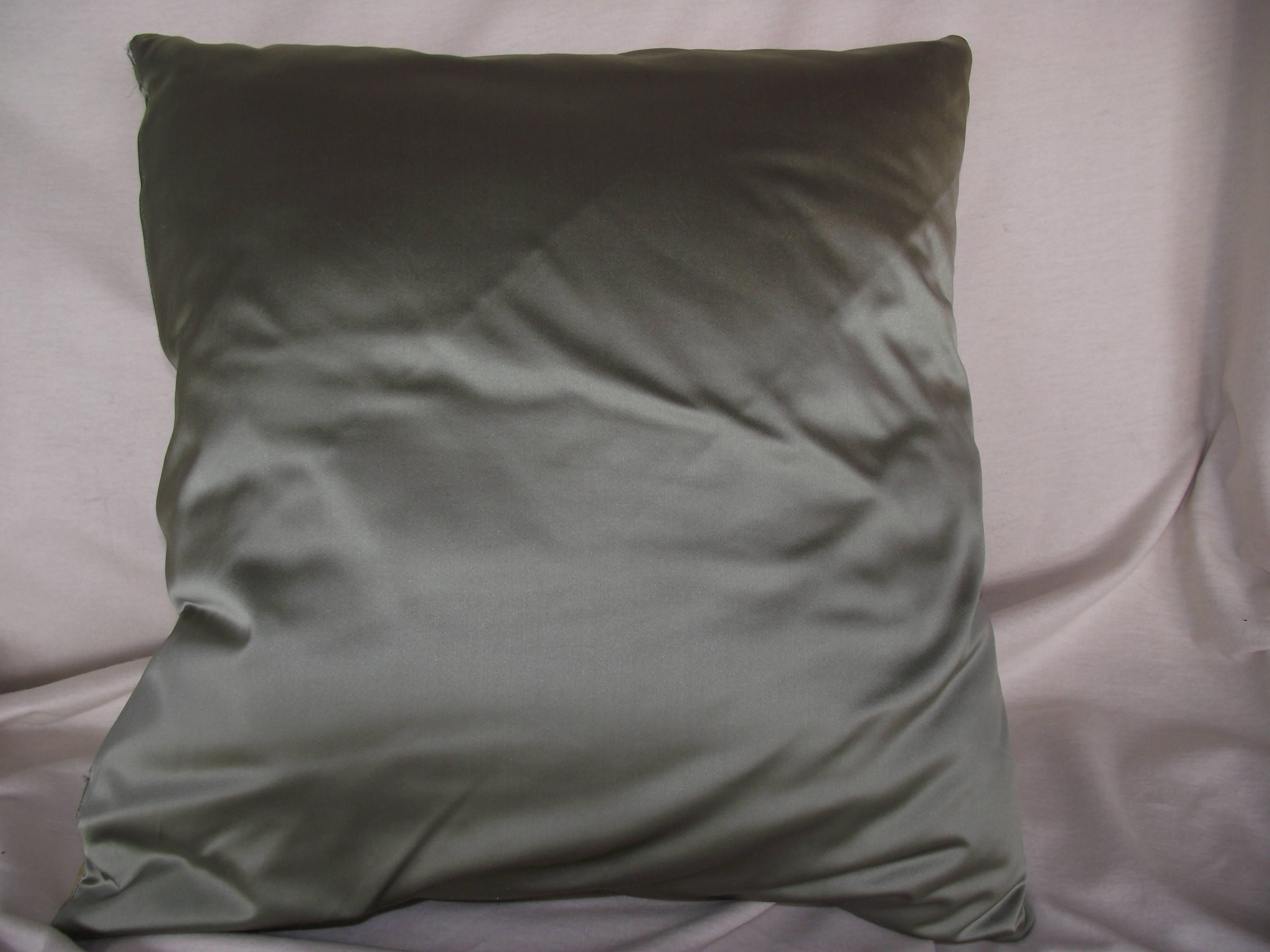 These two thick comfortable pillows are original designs from Gantt Design Studio. The original stripe made of cotton and satin fabrics is mitered and accented with two decorative trims. The back of the pillow is covered in a neutral grey green