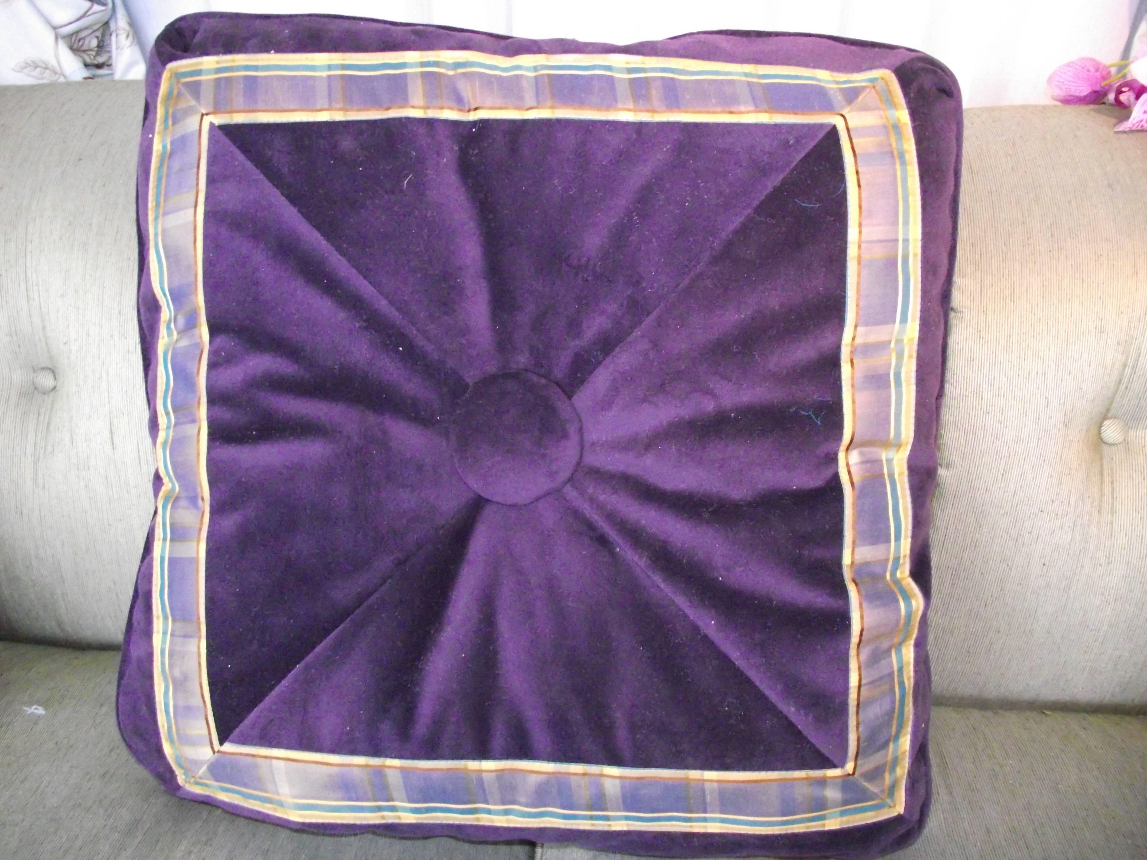 This GANTT designed comfort pillow is covered on one side with aubergine velvet trimmed with a plaid silk pattern. Both sides of this unusual pillow feature an over sized padded center button.

The opposite side is covered in the same velvet with a