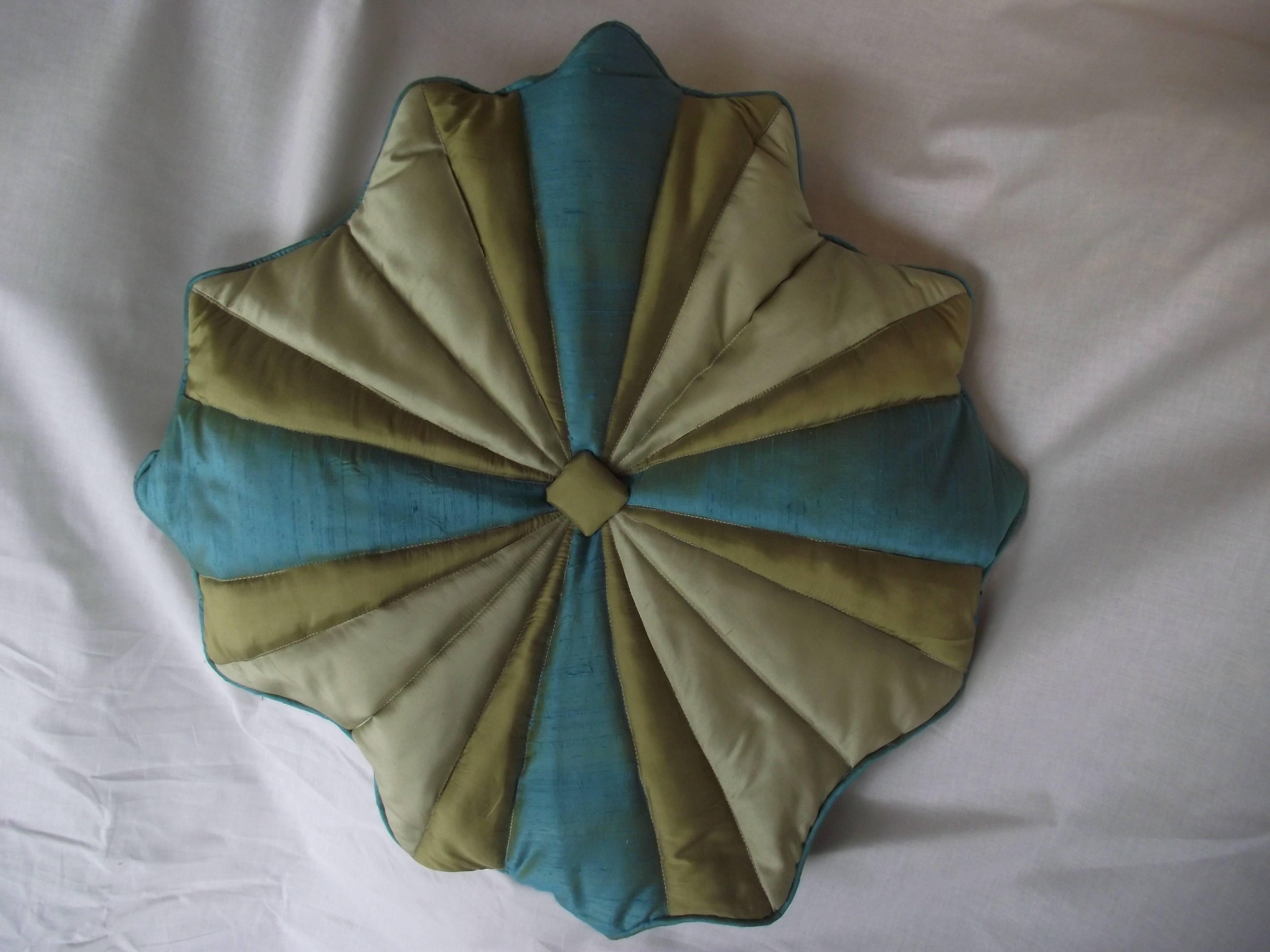This another original design from Gantt's Design Studio. This striking pillow is made joining turquoise dupioni silk and gold shantung silk and quilting the cover at the seams. 

The back is solid gold silk with the same pattern quilted into