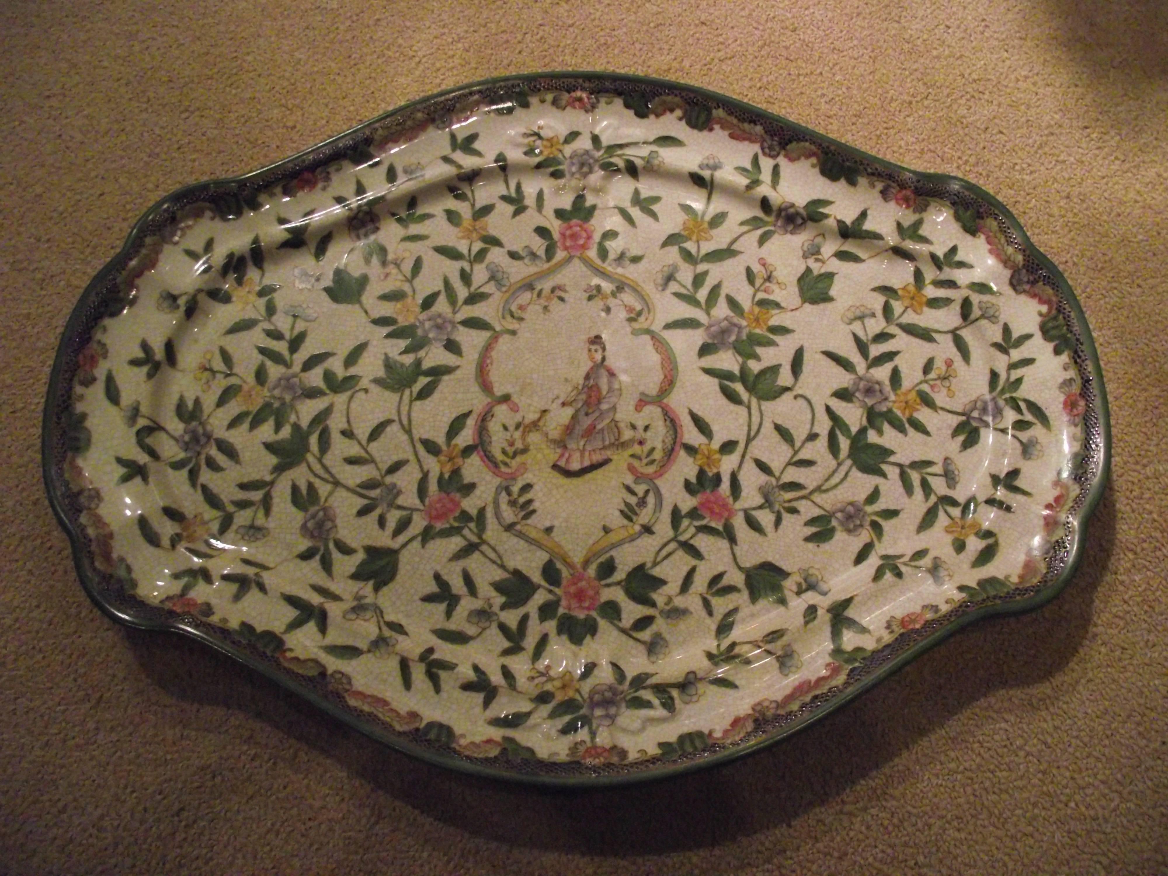 These beautifully detailed pottery platter and plates have a warm crackled aged appearance.

They look to be hand-painted but are more likely decals.

The edge design of the plates is pierced.

The platter is 14