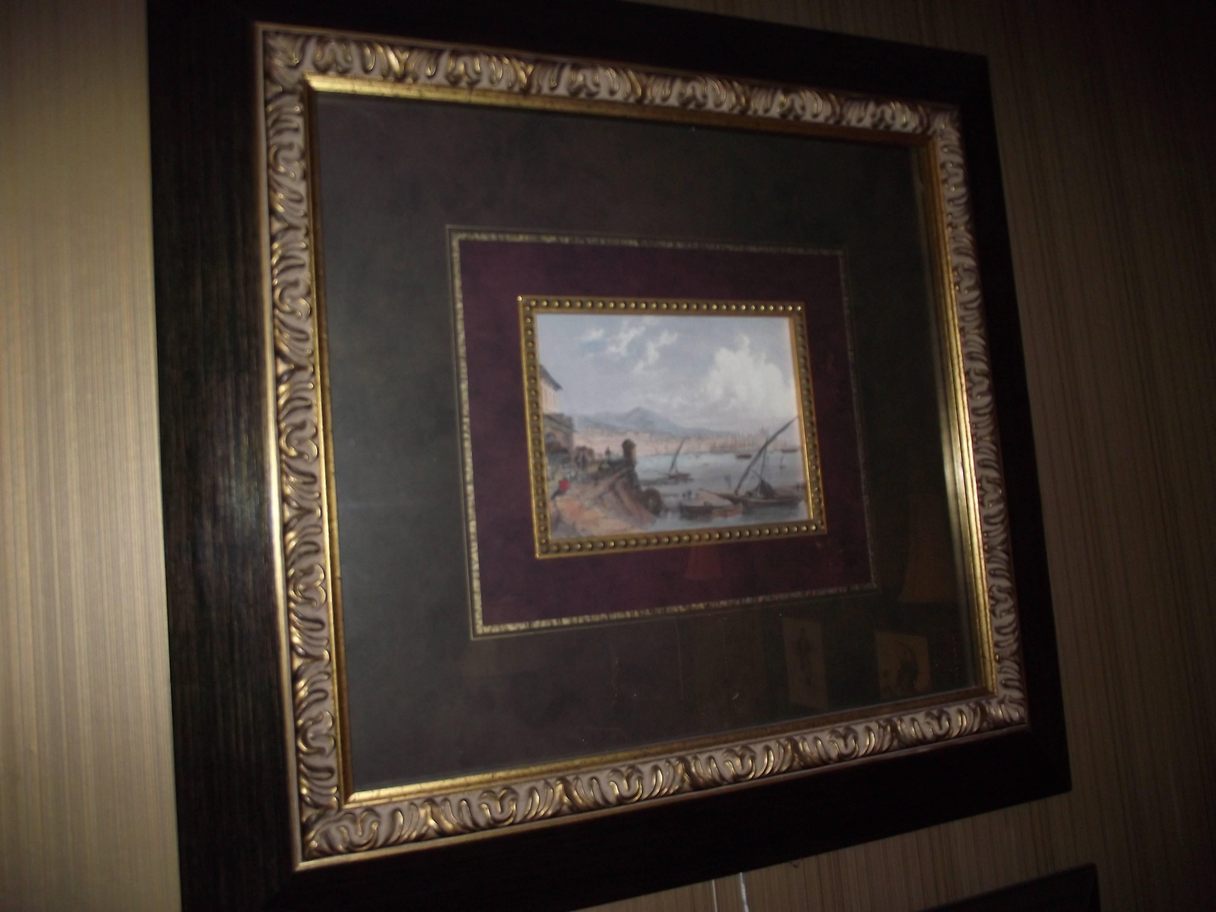 This pair of double matted Venetian Prints have warm tones that work in many traditional settings. The brown black wooden frame with gold leaf accents has a mottled dark green outer mat, a gold filet, followed by a deep plum center mat with another