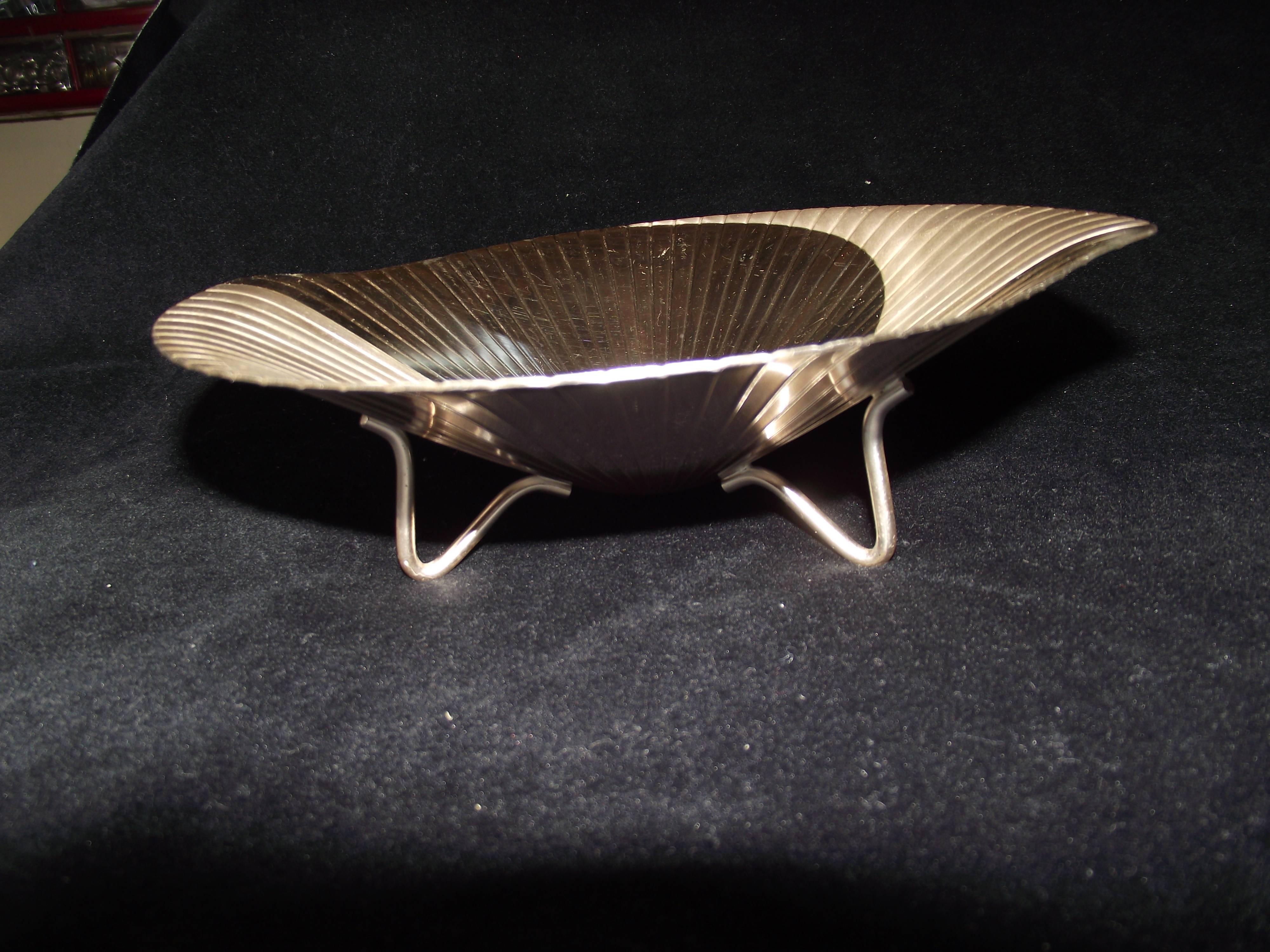This flat and polished silver bowl is captivating!

Made in 1933 by WMF-Wurtembergishe Metallwarenfabrik it is more a work of art than a serving piece. In my home it would go on a plate stand on a shelf.