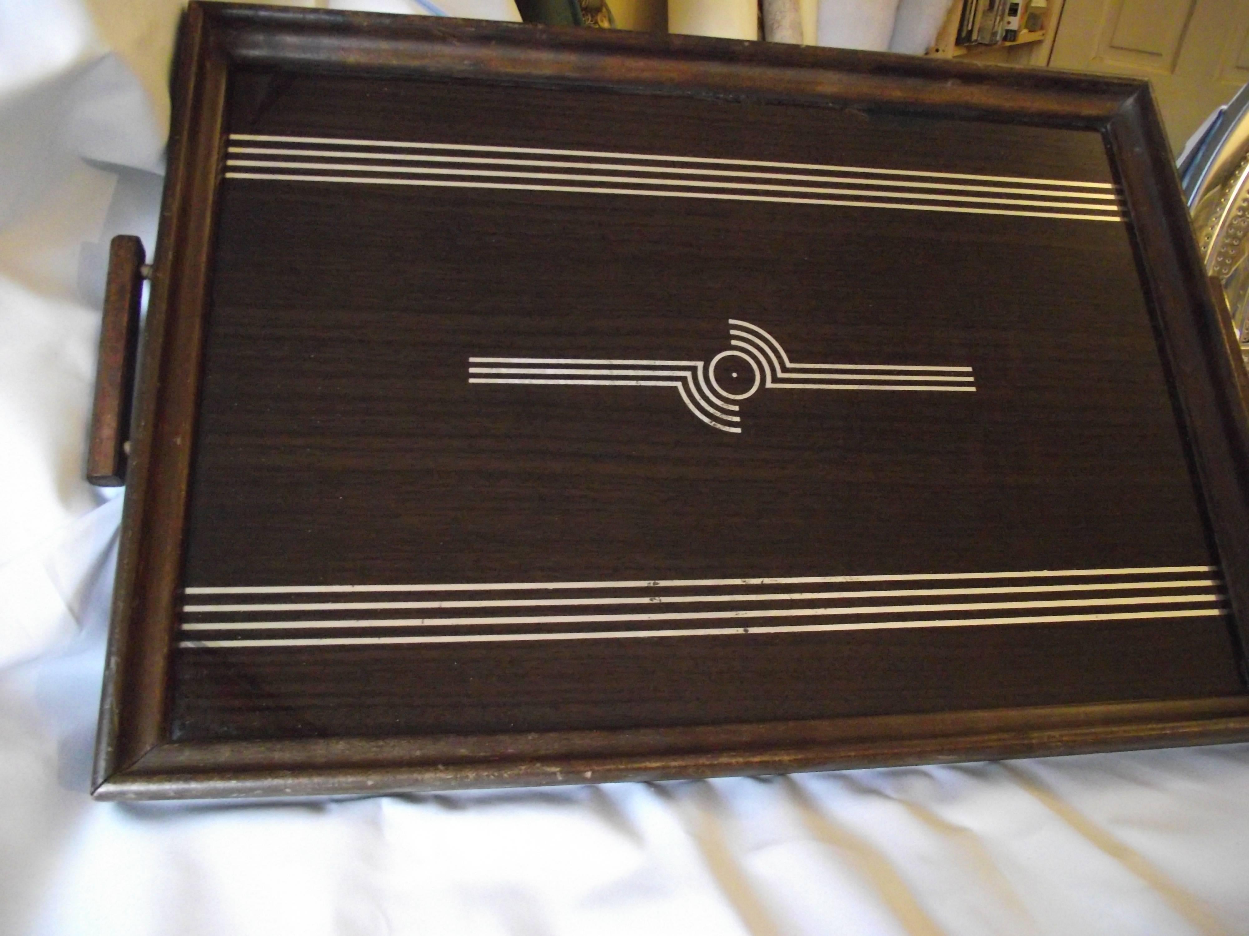 This Art Deco tray is outstanding. The reverse painted glass surface features a great Art Deco mirror design surrounded by a painted faux wood grain. I tried to capture in the pictures an almost unnoticeable repair to the wood grain treatment in the