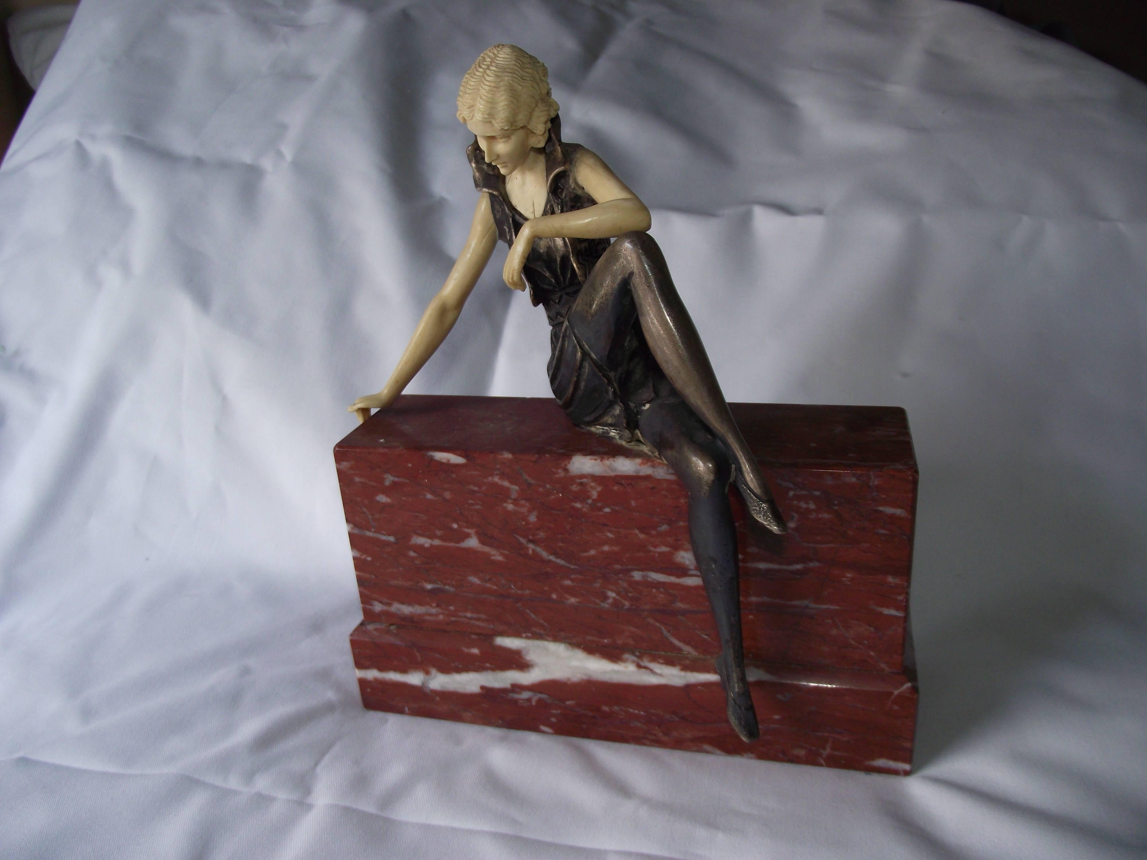 A period replica, this sculpture was made in the same fashion as Ferdinand Preiss. This confident flapper sits cross legged on a wall of sienna marble.

Like Preiss it is cold painted bronze the flesh colored pieces are delicately carved to fit