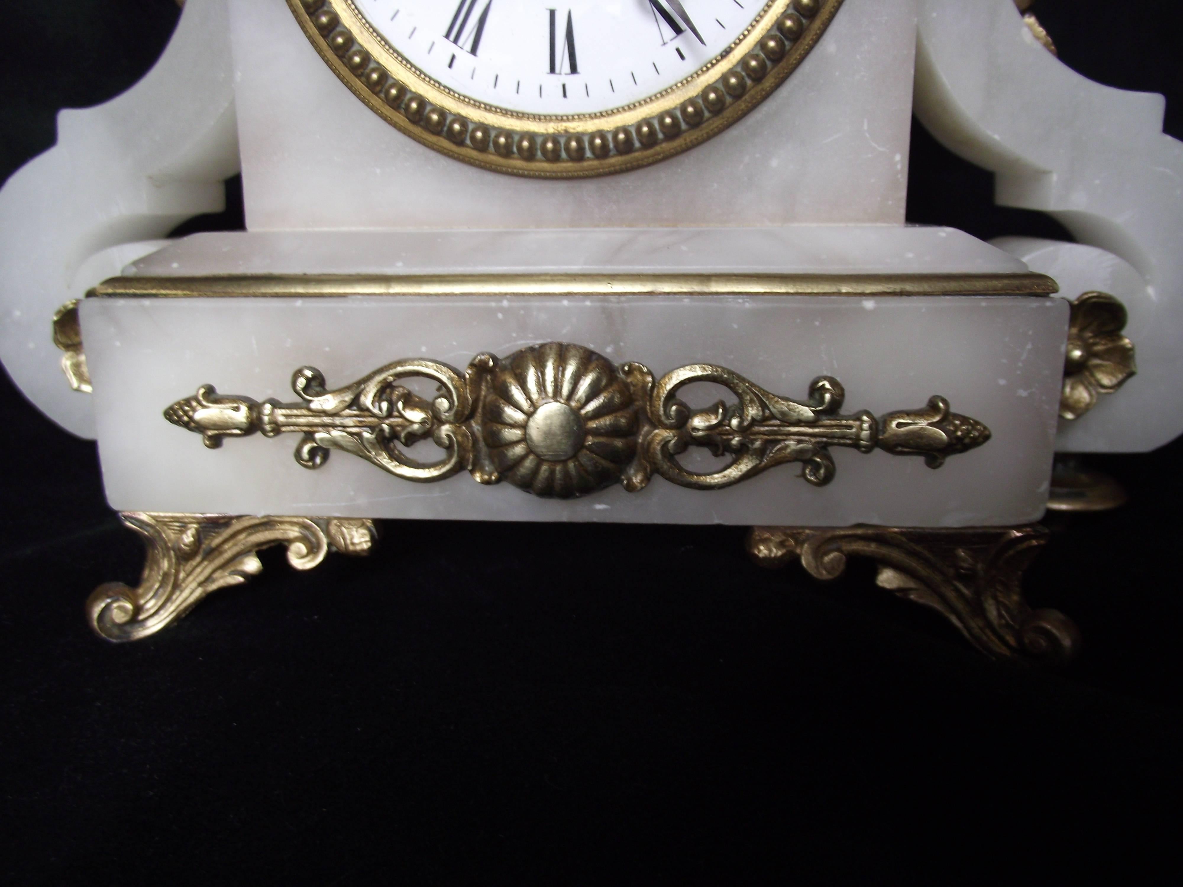 This beautiful Victorian carved alabaster clock features a bust of a beautiful woman on the top.

The alabaster is in very good shape for it's age. It has a few little flea bites here and there but they do not detract from the beauty of the