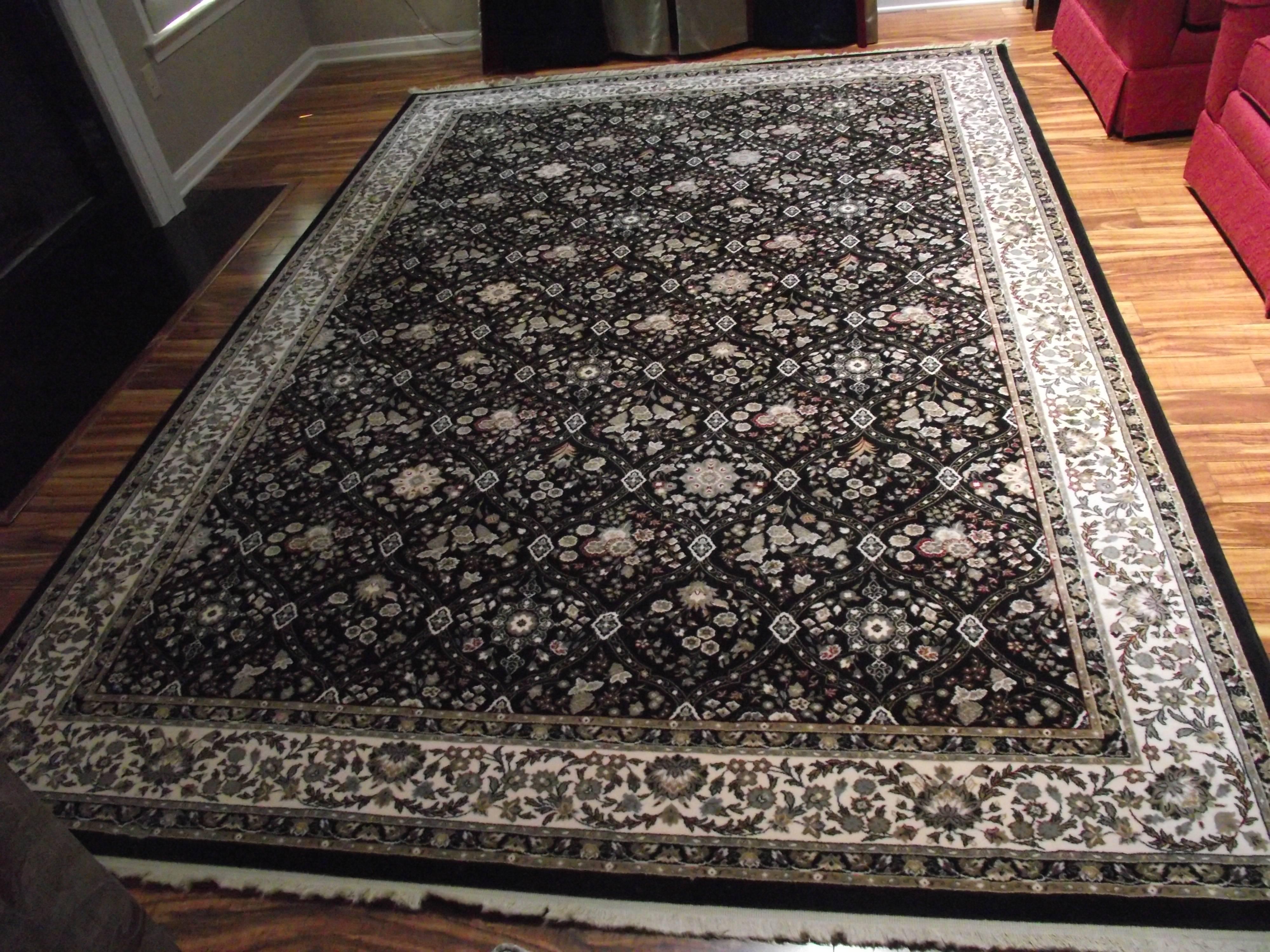 This beautiful Belgium rug has a black background with decorative detail in beige, white, grey and red.

It has no stains and shows no signs of wear.
