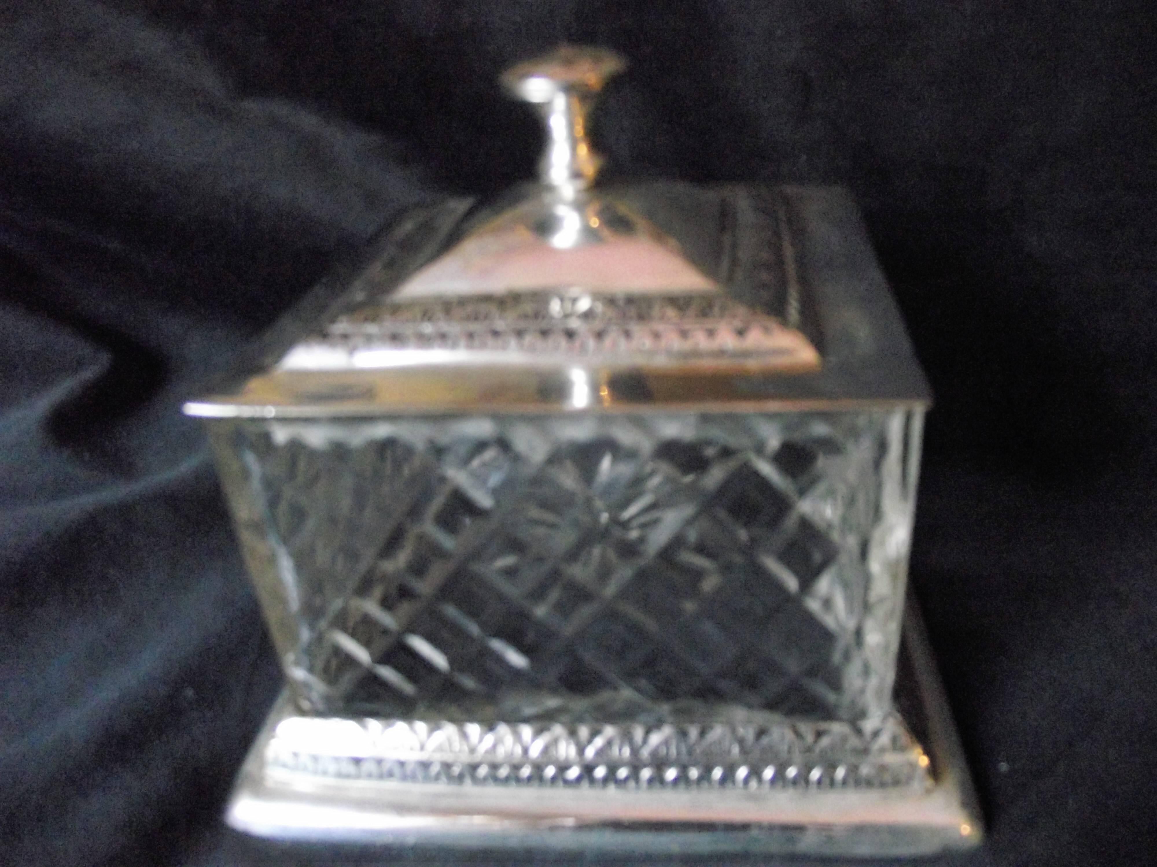 This little box is very elegant! It's pressed glass sides and bottom are very decorative and has no chips or cracks. The silver plate base is in near perfect condition. The silver plate lid has a few dings commensurate with it's age and use. All