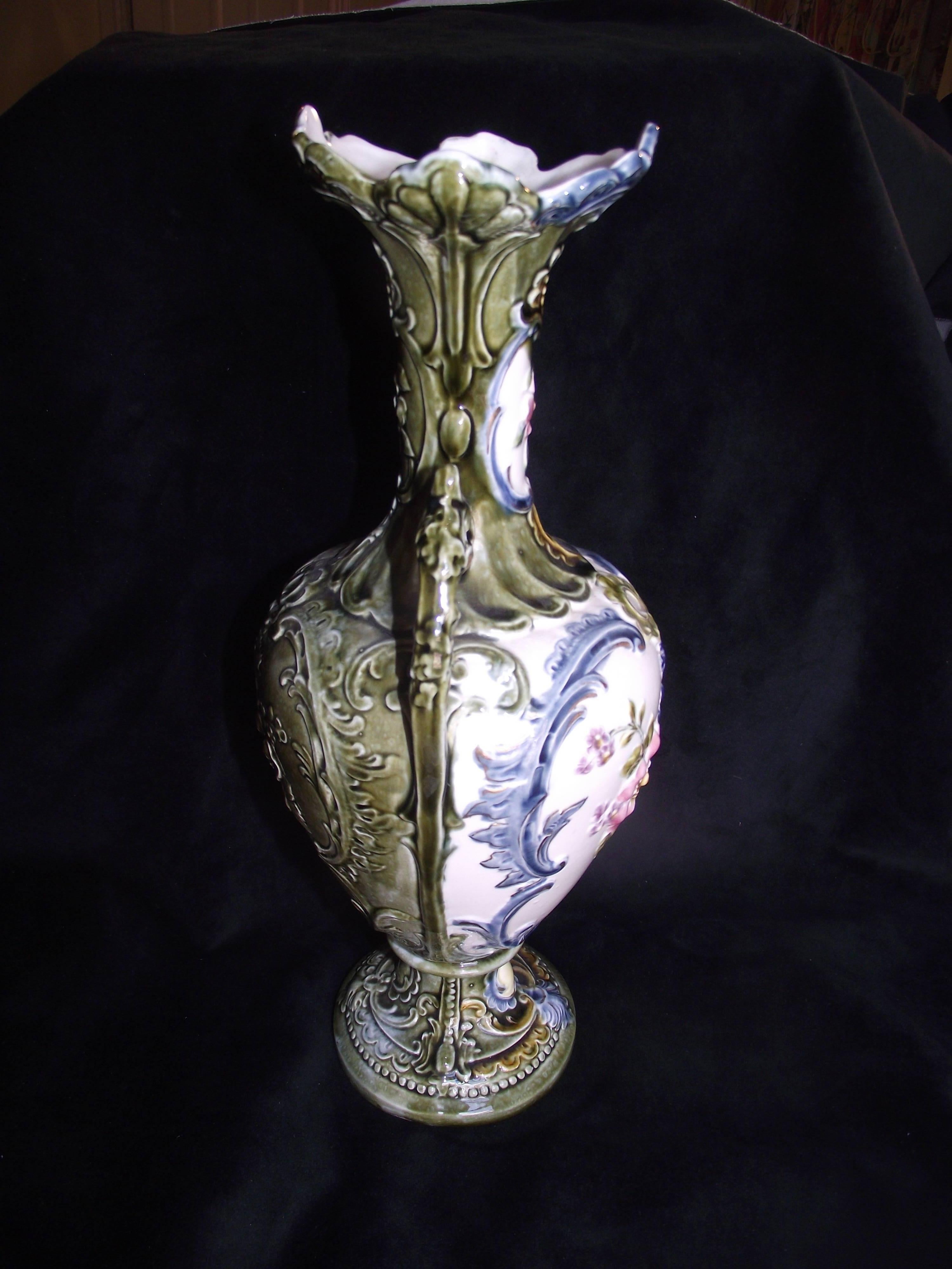 Nice sized Majolica two handled vase. Beautifully decorated. No chips, cracks or crazing to the glaze. It looks to me to be Italian but cannot make out the mark.