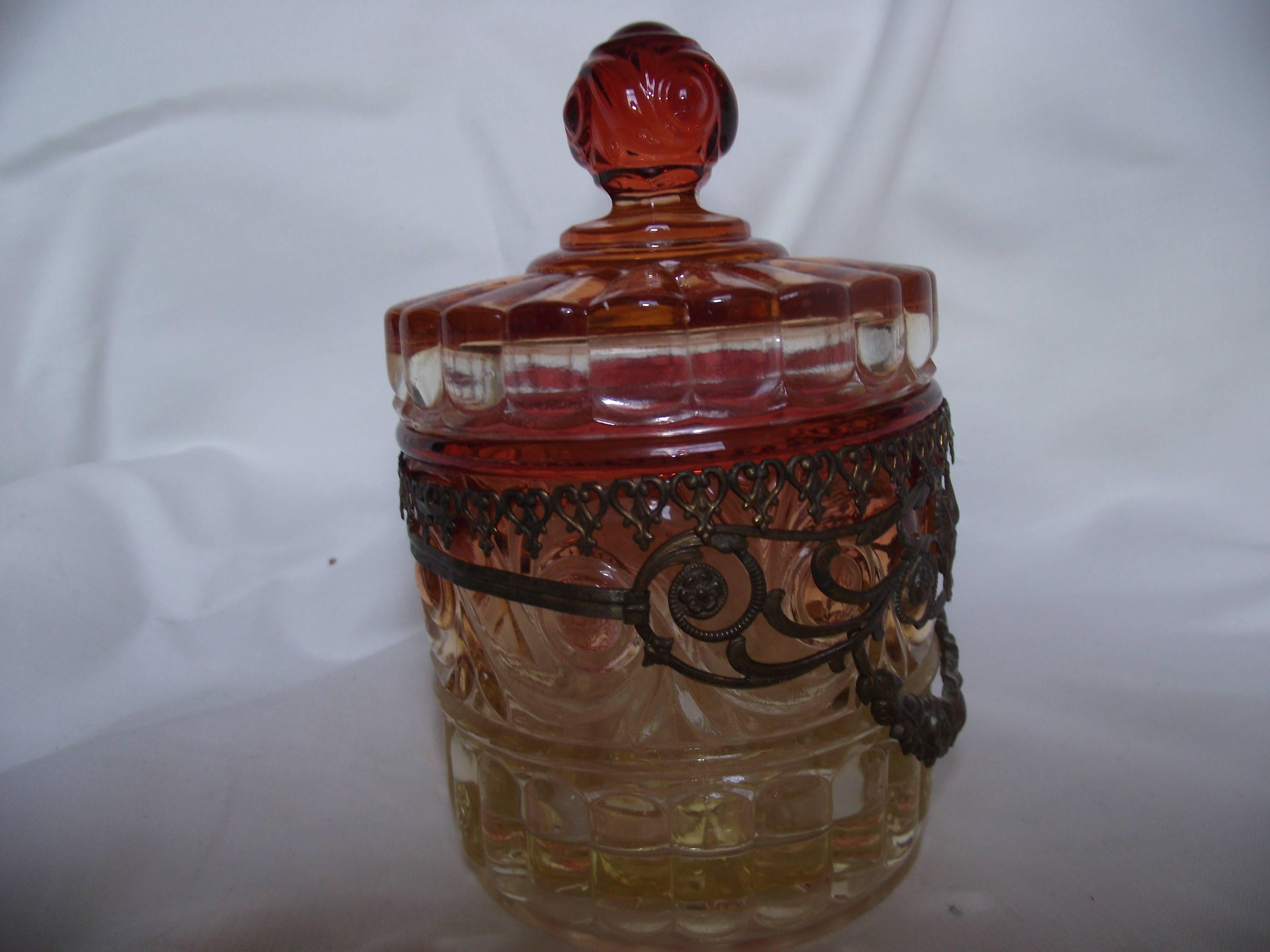 This little jar is known as Baccarat's Amberina Rose Tiente(tint). This pattern was made originally in 1916, discontinued during the war and reintroduced in 1940. The color tints were produced by adding a small amount of gold to the clear glass