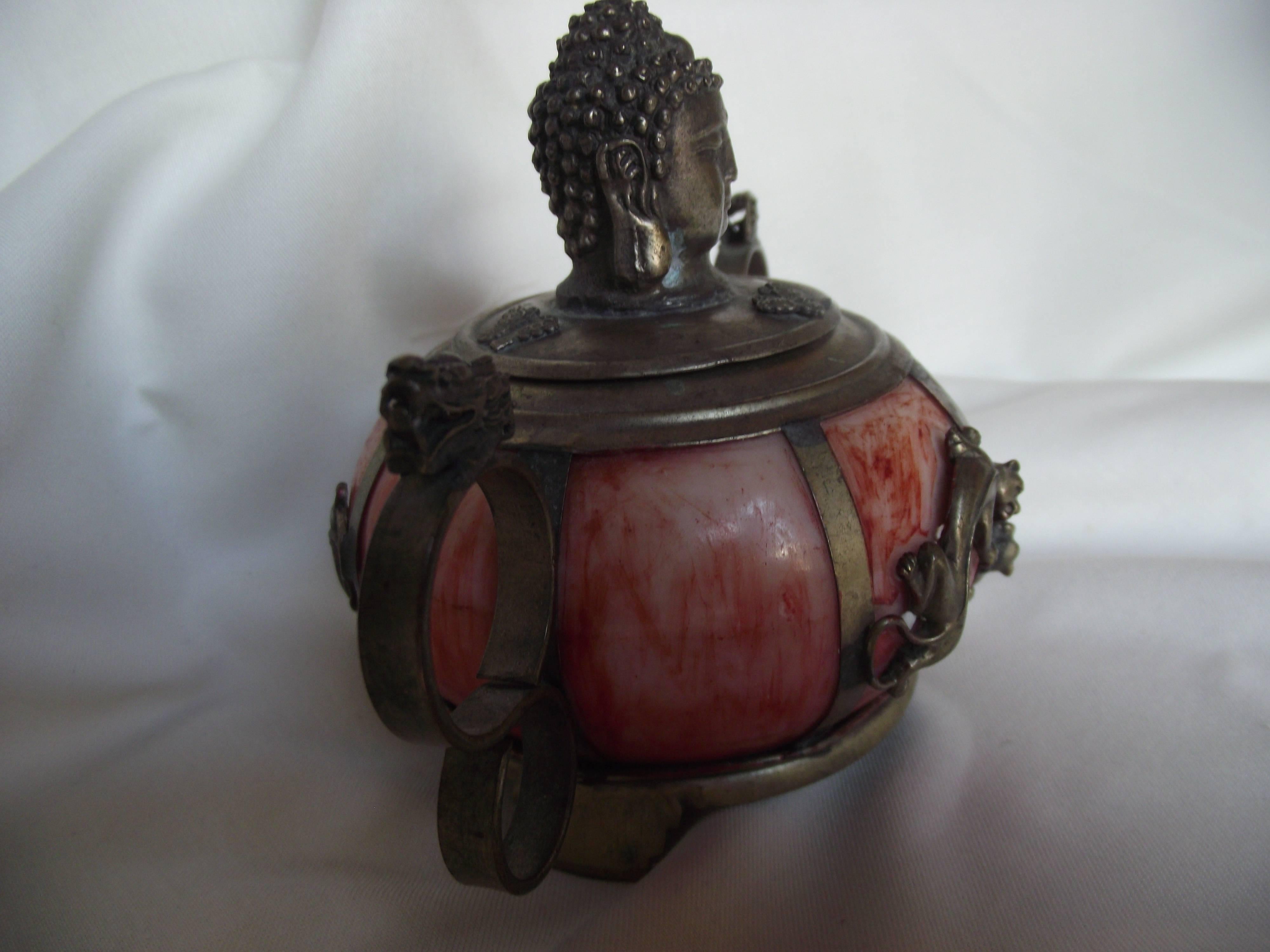 This chamming little incense burner is probably from the 1940s. It is signed on the bottom. The main part is made of carved hard stone, The Buddha head lid is brass as well as the handles, bottom, legs and dragon trim details.