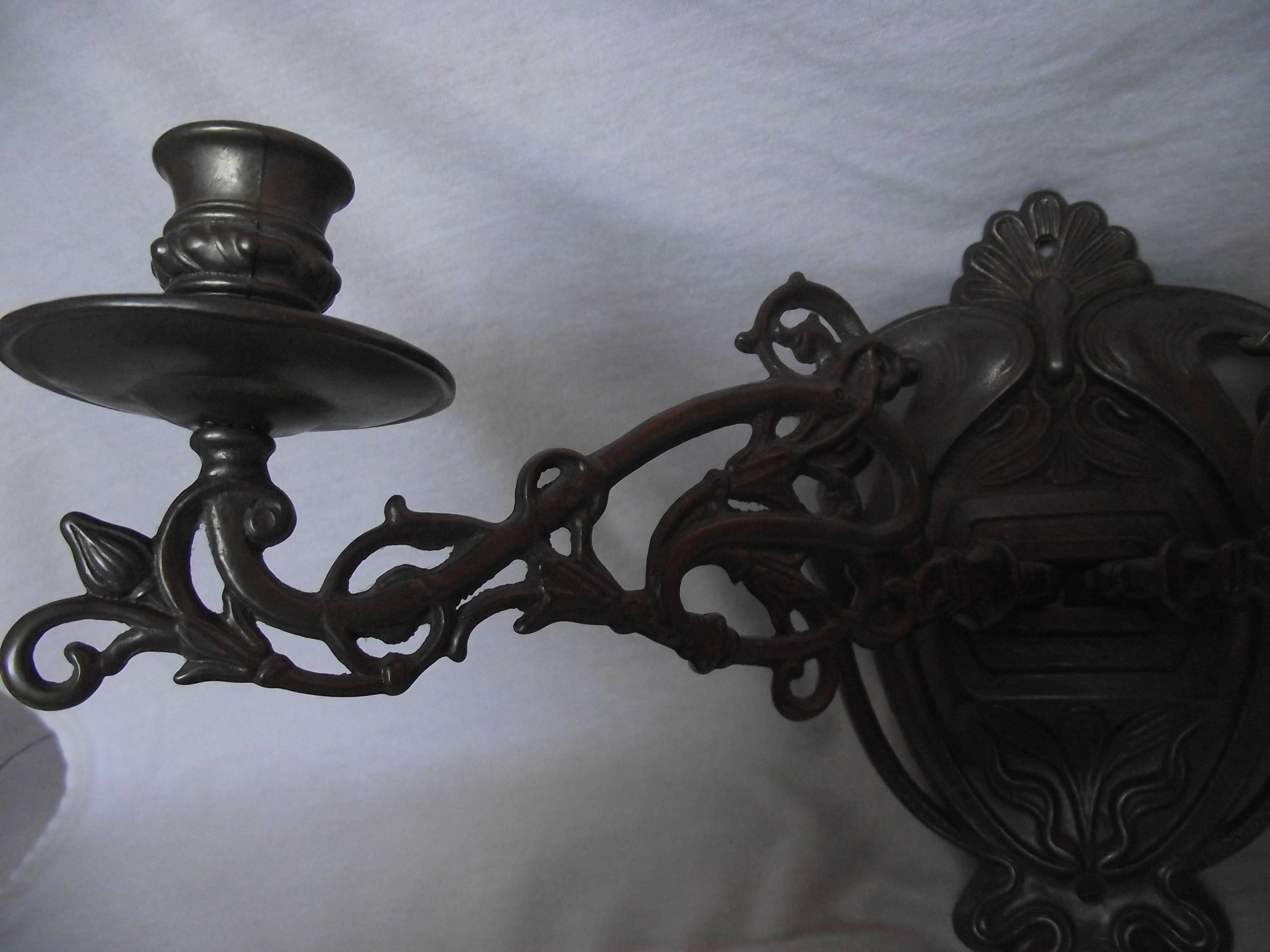Nice pair of Art Nouveau swing arm candle sconces in bronze finish.