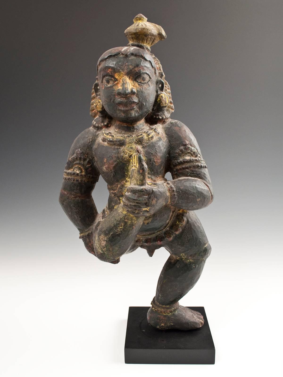 Offered by Zena Kruzick.
Mid-20th century carved wood Krishna figure, India, possibly Rajasthan.
Wonderfully animated carving of Krishna holding his right foot in front of his torso, likely a yoga asana. Remnants of yellow puja offering can be