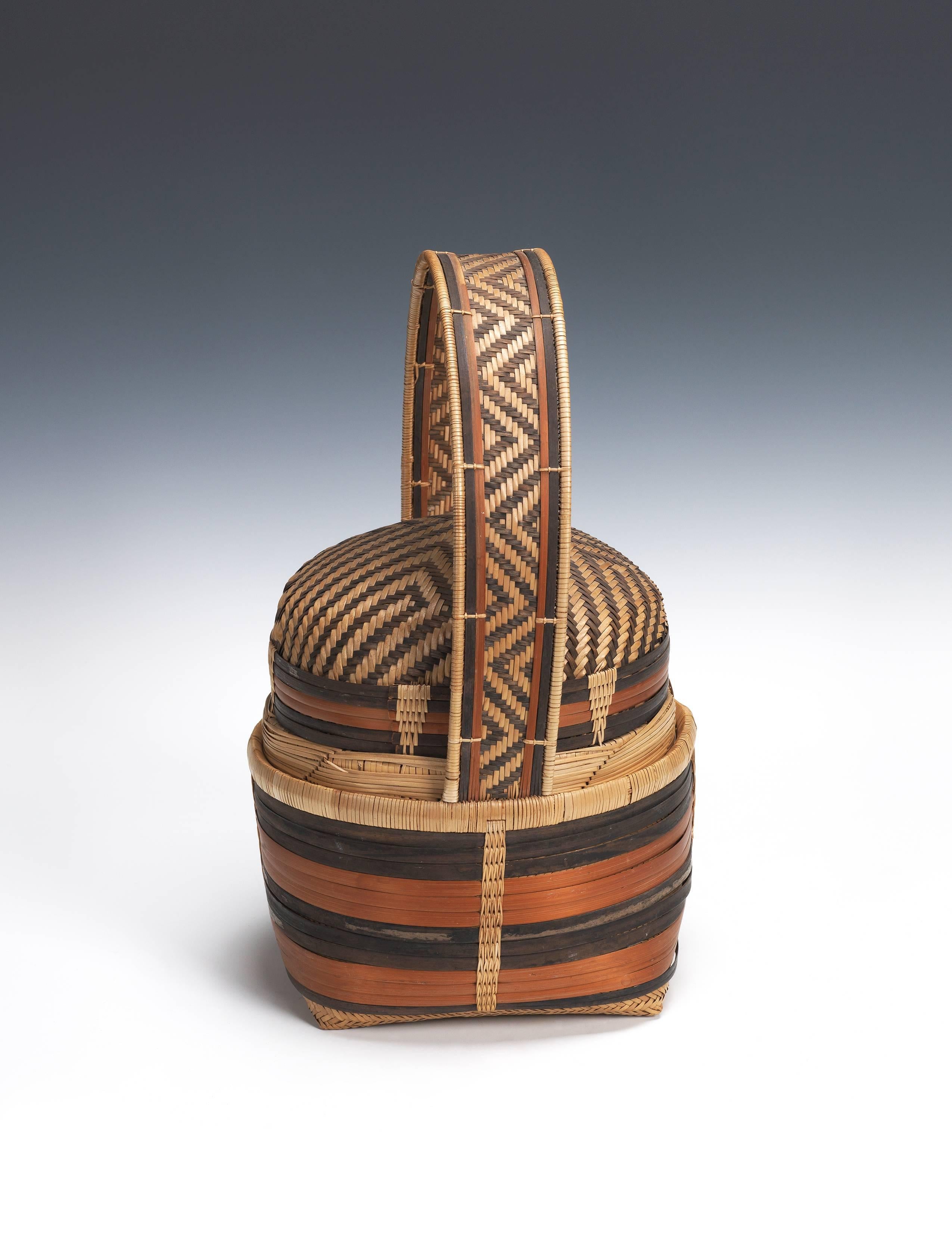 Offered by Andres Moraga
20th Century Tribal Songye Basket, Angola or DR Congo, Africa

Two-part basket with basketry handle. The top part lifts out from the bottom.
Made of strips of wicker and a different natural fiber, vegetal dyes
A similar