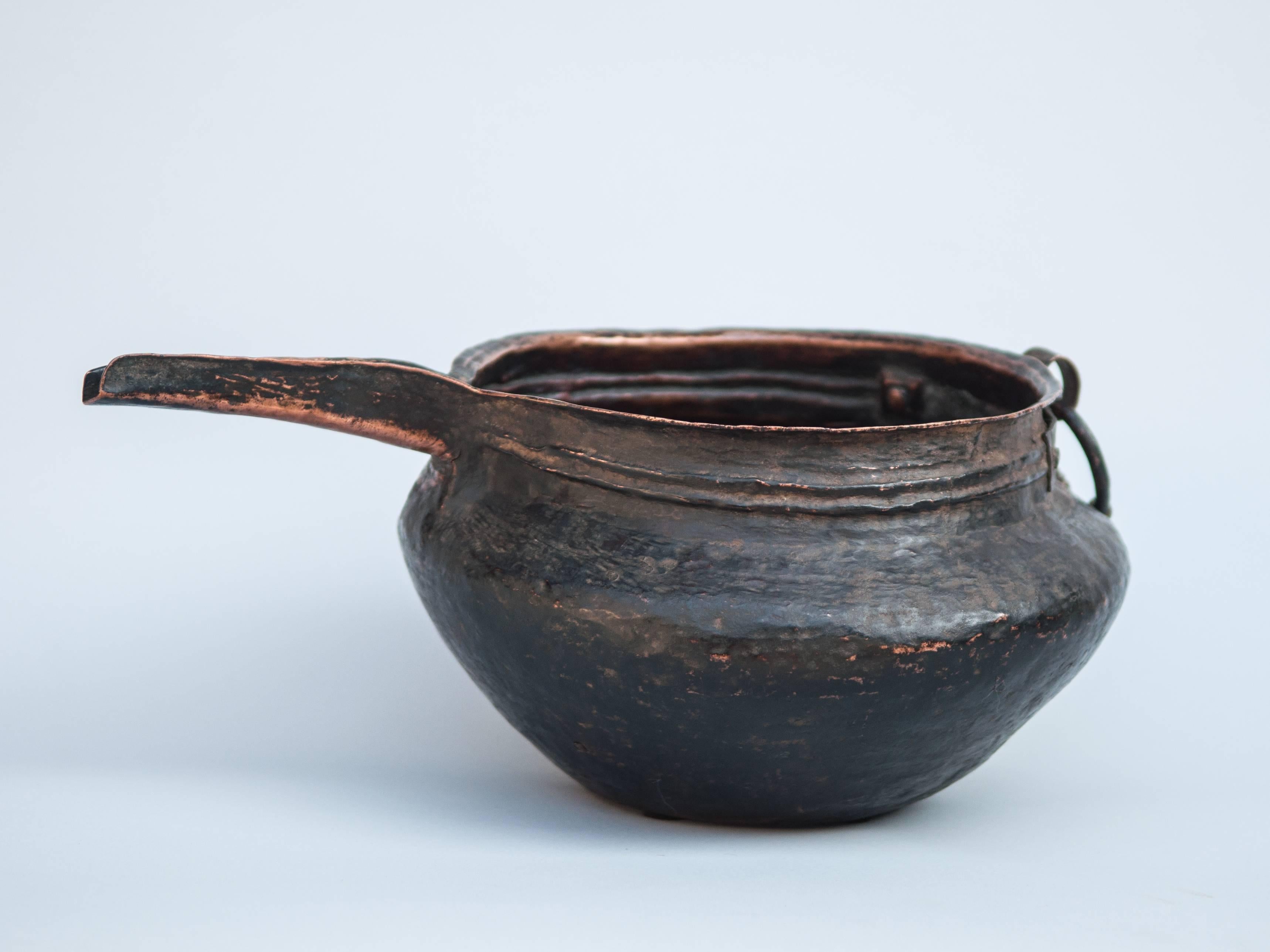 Copper pot with spout. Hand-hammered. Tibet. Mid-20th century.
This pot was used in making Chang, the fermented alcoholic drink so popular with the Tibetans, and which plays such an important role in daily social interactions and in showing