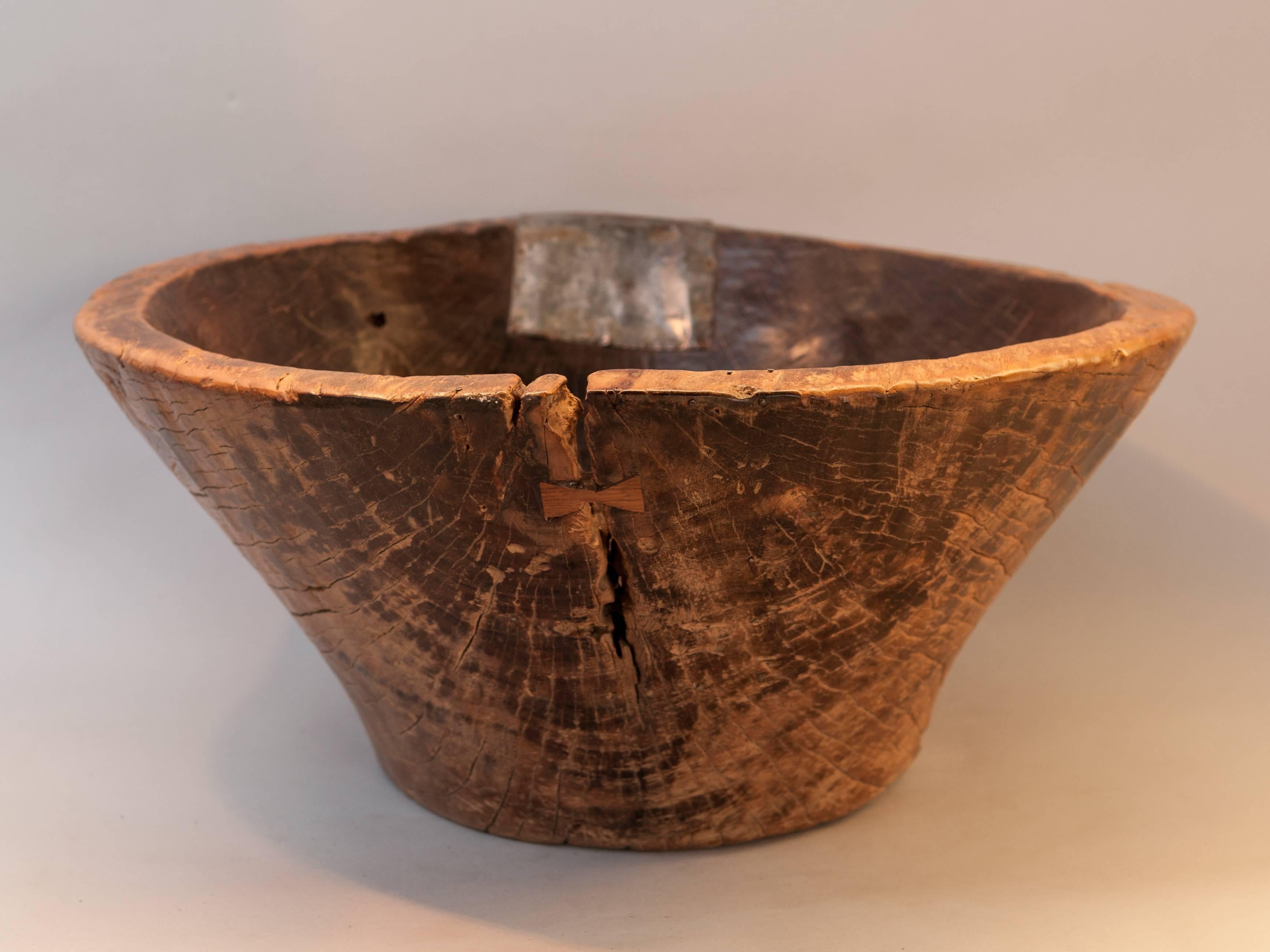 Large hand hewn wooden bowl. Cirebon, Java, mid-20th century. Jackfruit wood.
This rustic wood bowl was fashioned by hand from a single piece of Jackfruit wood and comes from the Cirebon area of northern Java. It would have been used to offer foot