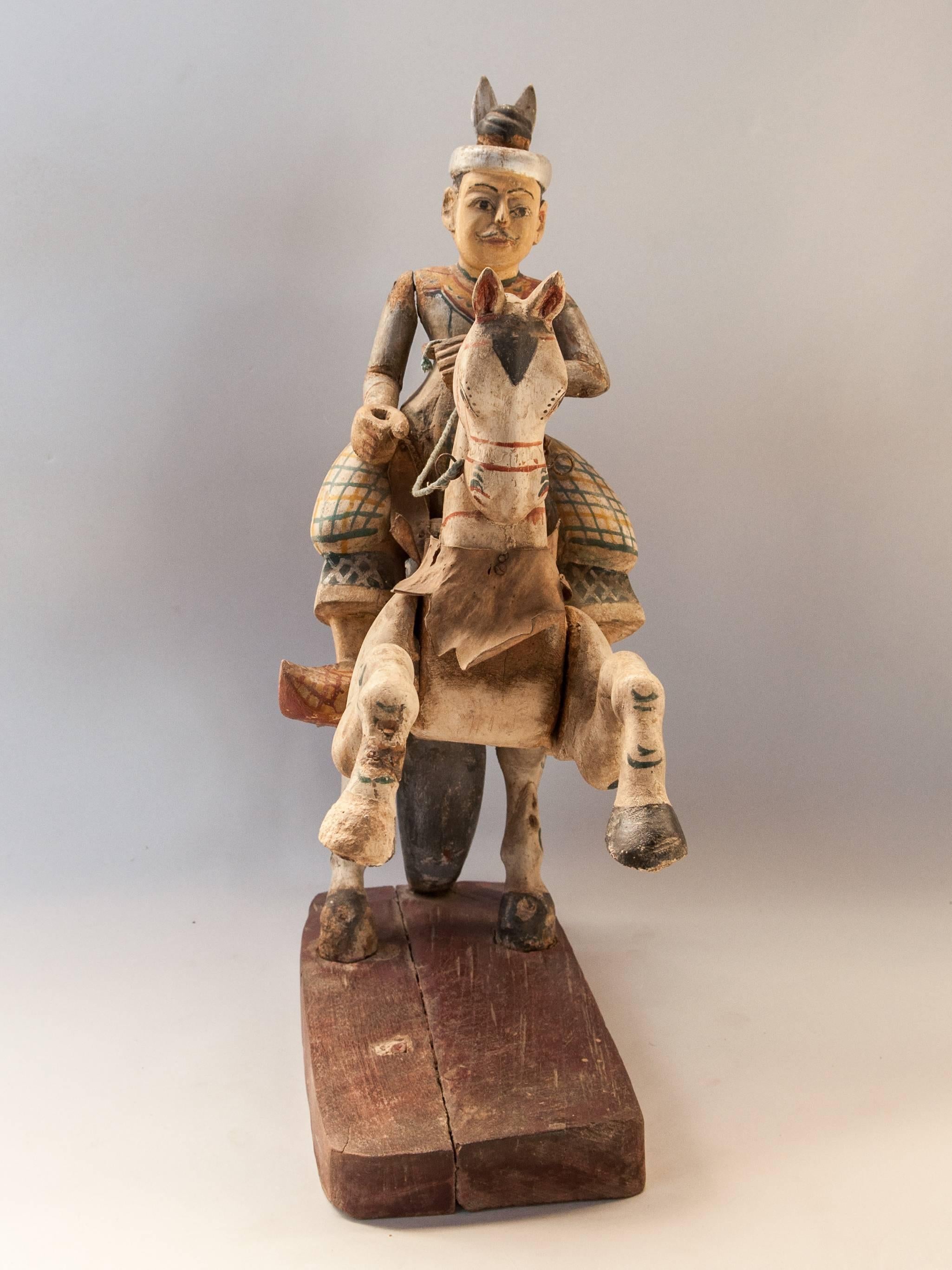 Wood Nat spirit figure min Kyawzwa Burma early to mid-20th century.
Min Kyawzwa is one of the more colorful figures in the pantheon of 37 Great Nats (spirits) officially recognized in the Burmese Buddhist tradition. Depicted as a good horseman, a