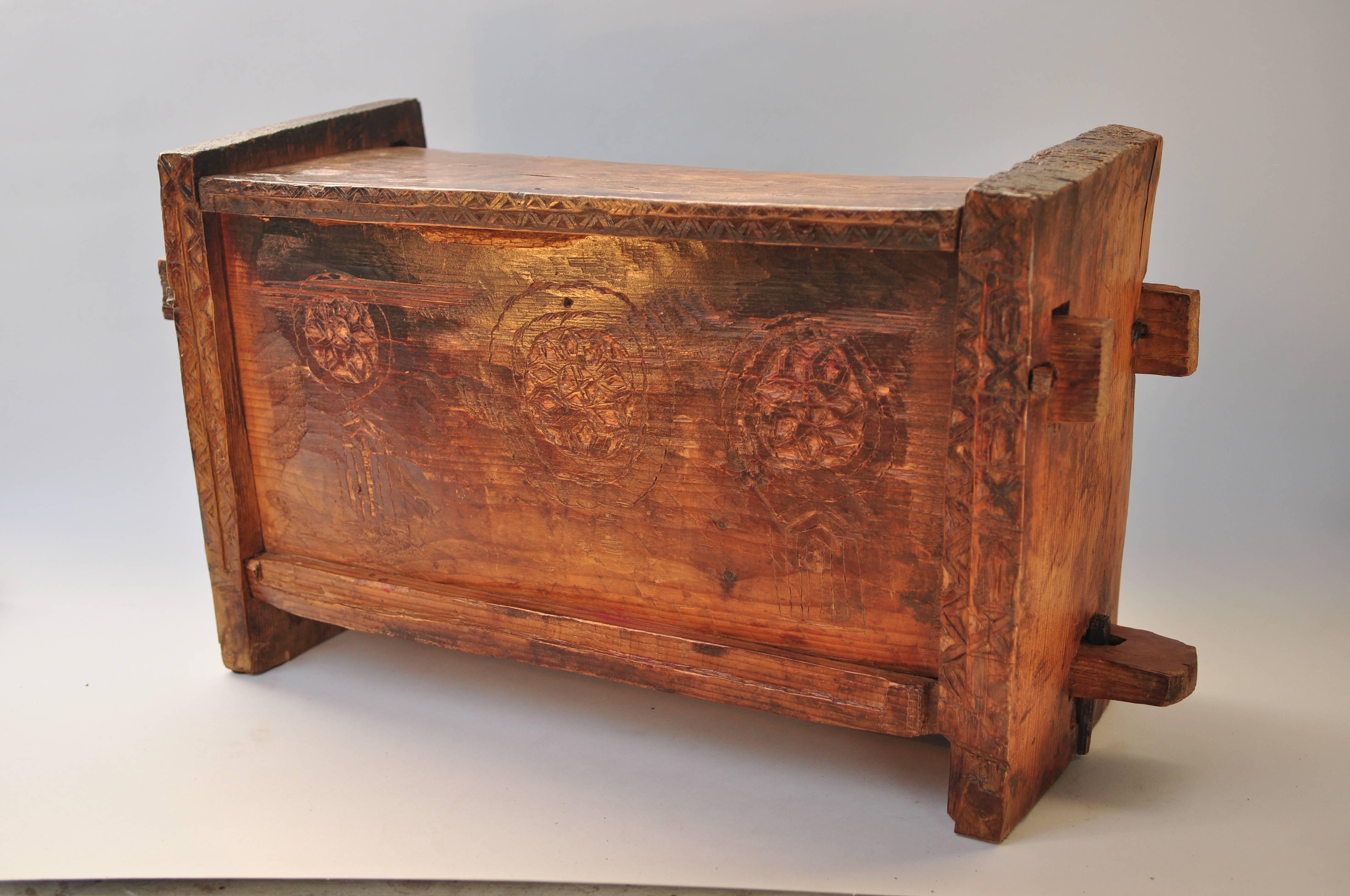 Primitive hand-carved wooden chest. Raute people of Nepal. Mid-Late 20th century.
Offered by Bruce Hughes.
This charming and very rustic wooden chest was made using basic tools and incorporates simple carved decorative motifs on the front. The box