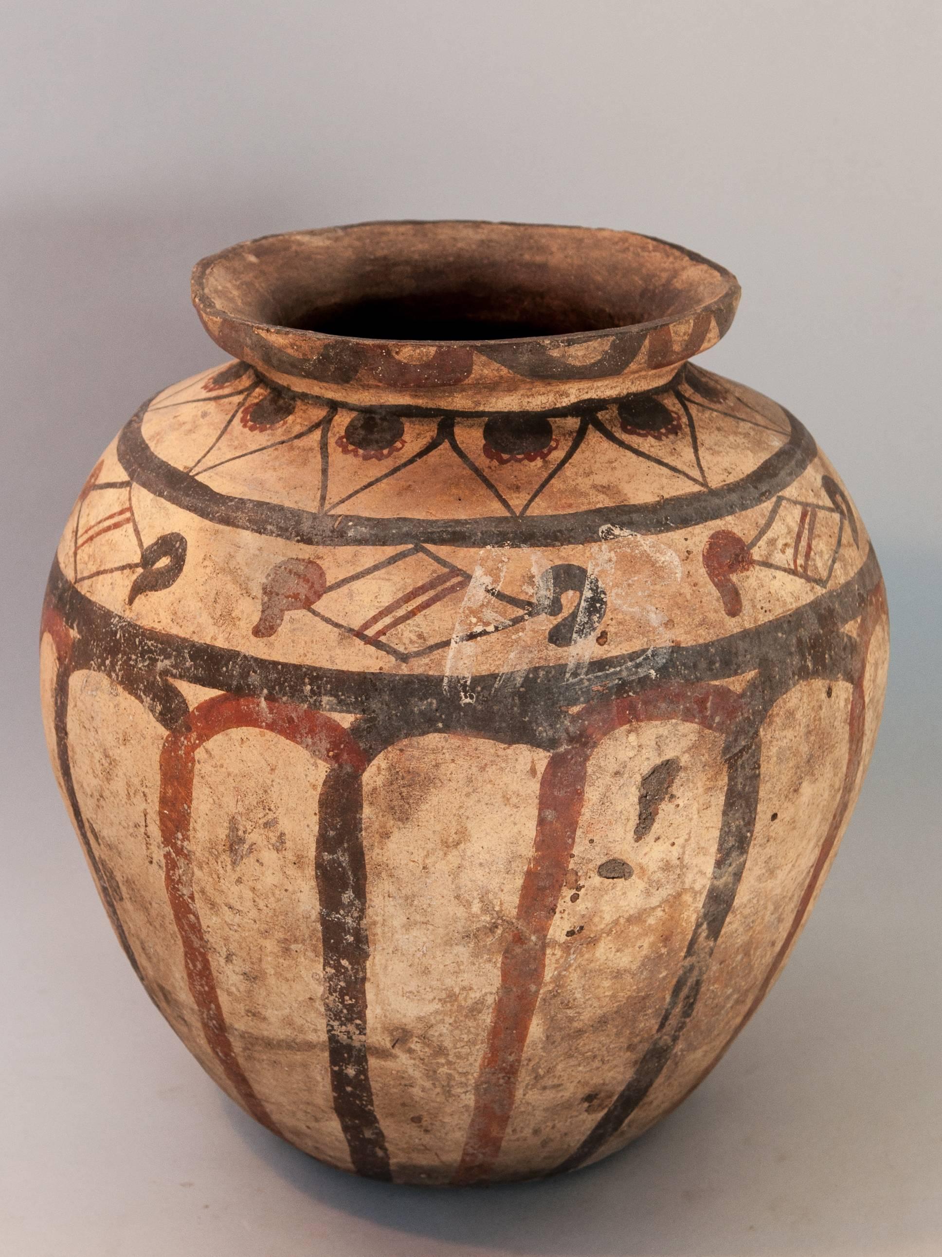 Earthenware Pot with Painted Design Mid-20th Century. Molucca Islands, Indonesia
This low fired earthenware pot is from the Southeast Molucca Islands, most probably from Kei. It is formed by hand, not thrown, using the fist and palm to achieve its