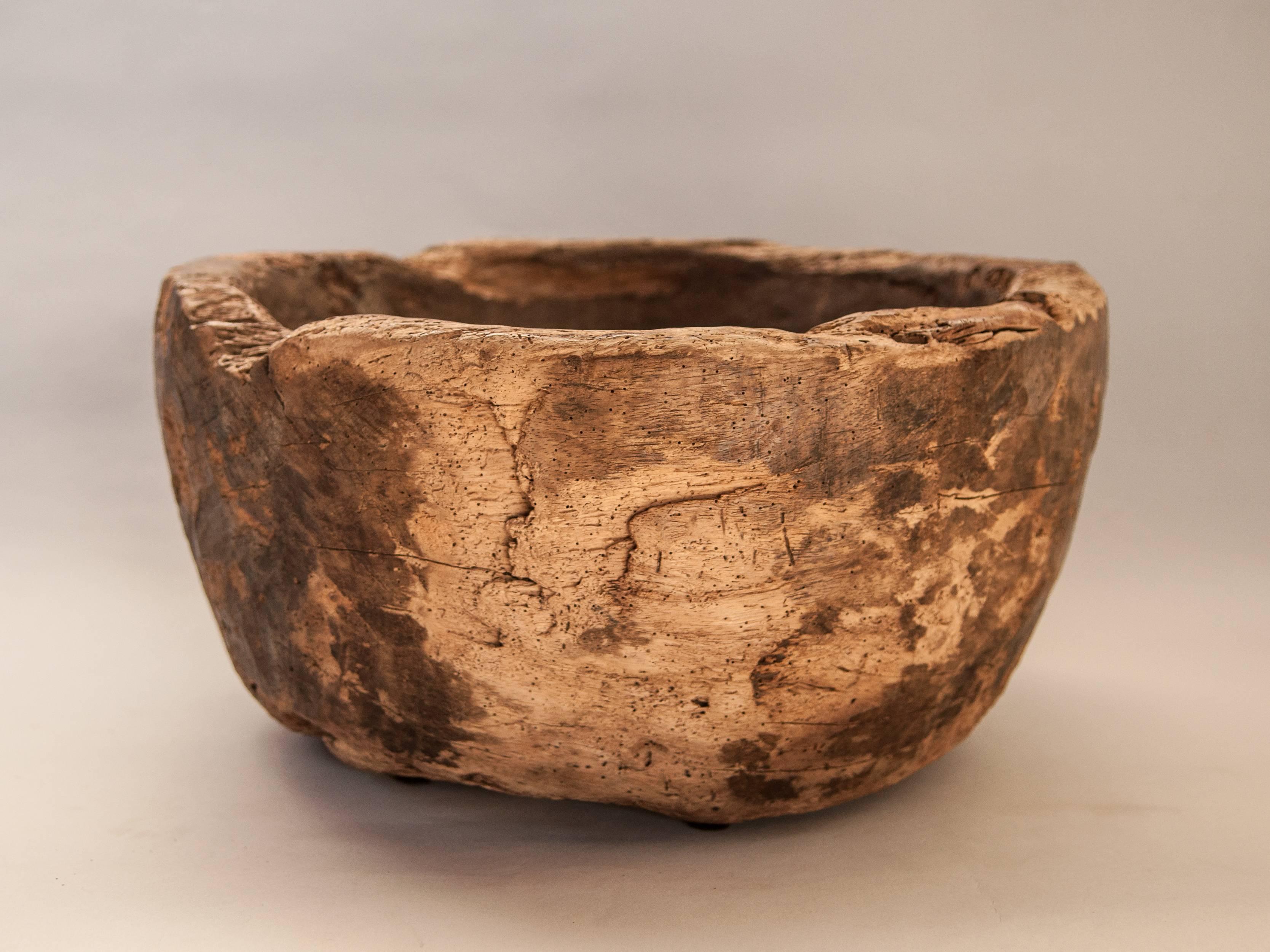 Rustic handhewn wooden bowl, Java, mid-20th century.
This rustic wooden bowl was fashioned by hand using very basic tools. It would have been used to hold grain or as a feed bowl for animals in rural Java.
Measures: 17 inches diameter x 8.5 inches