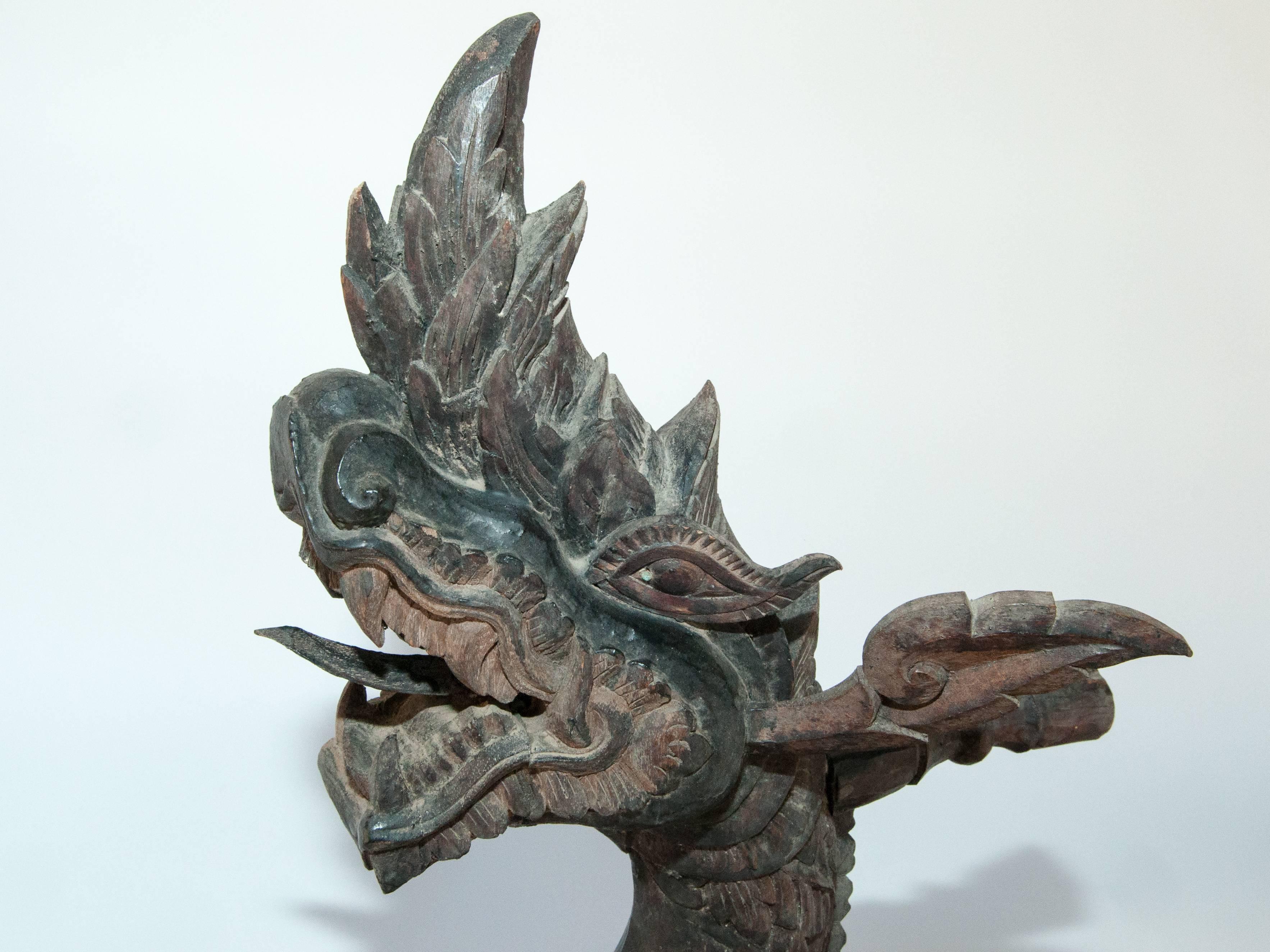 Carved silk winding tool from Laos. Naga motif. Early-20th century.
This reeling tool is elaborately and exquisitely hand-carved from a very dense local hardwood in a representation of a Naga, the spirit of the waters and bringer of fertility and