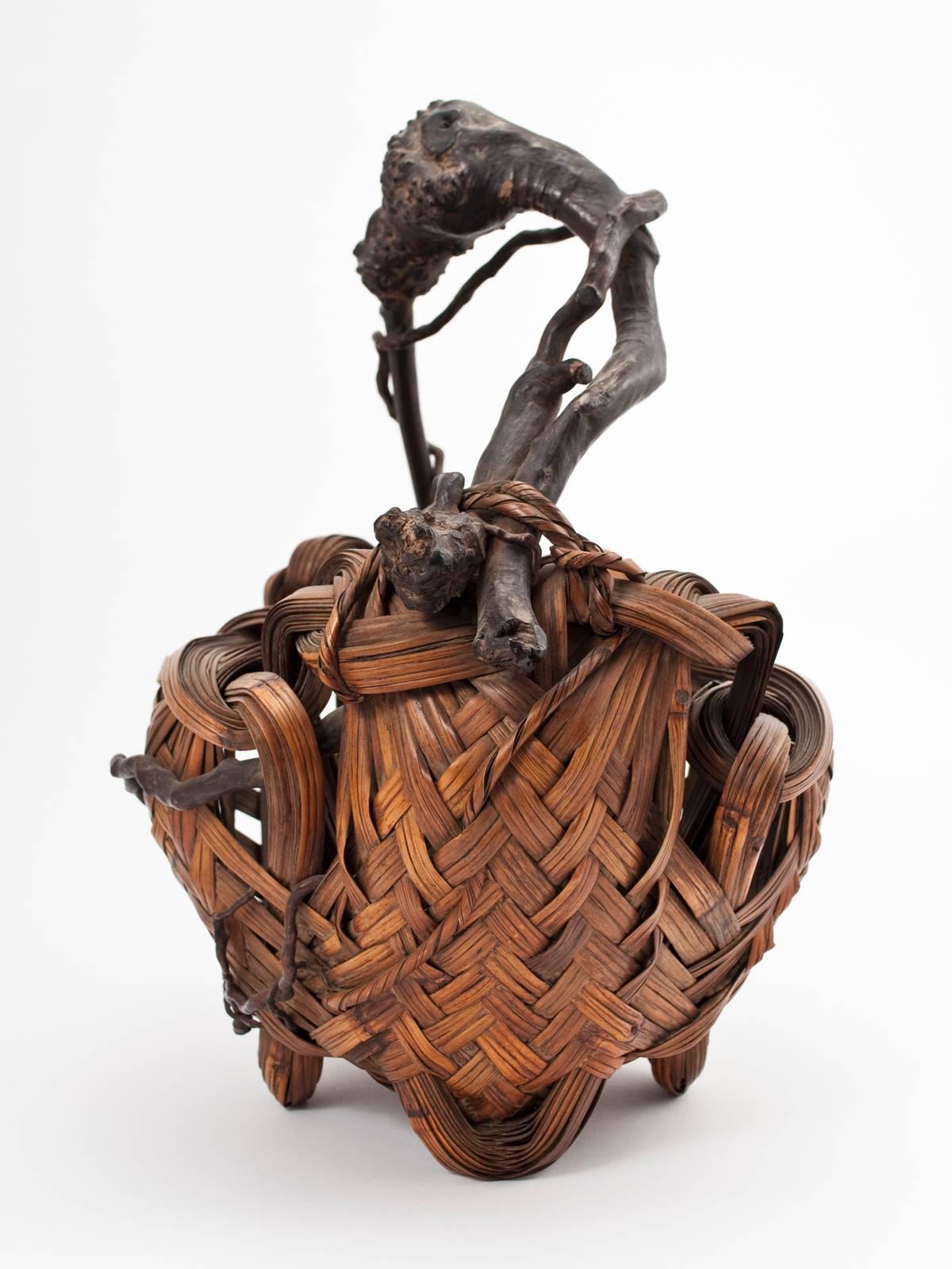 Offered by ZENA KRUZICK
Meiji Period Bamboo Ikebana Basket, Japan Made from Nemagaridake bamboo and vines.

Asymmetrical Japanese ikebana basket made of woven pieces of split Nemagaridake bamboo. The handle is made of twisting branches and vines,